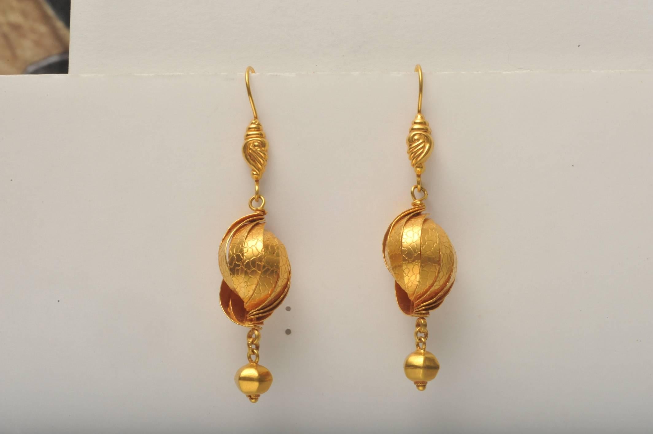Pair of 22K gold art deco dangle earrings with hand-tooled textured workmanship.  On a french wire for pierced ears.  Fine details and craftsmanship.
