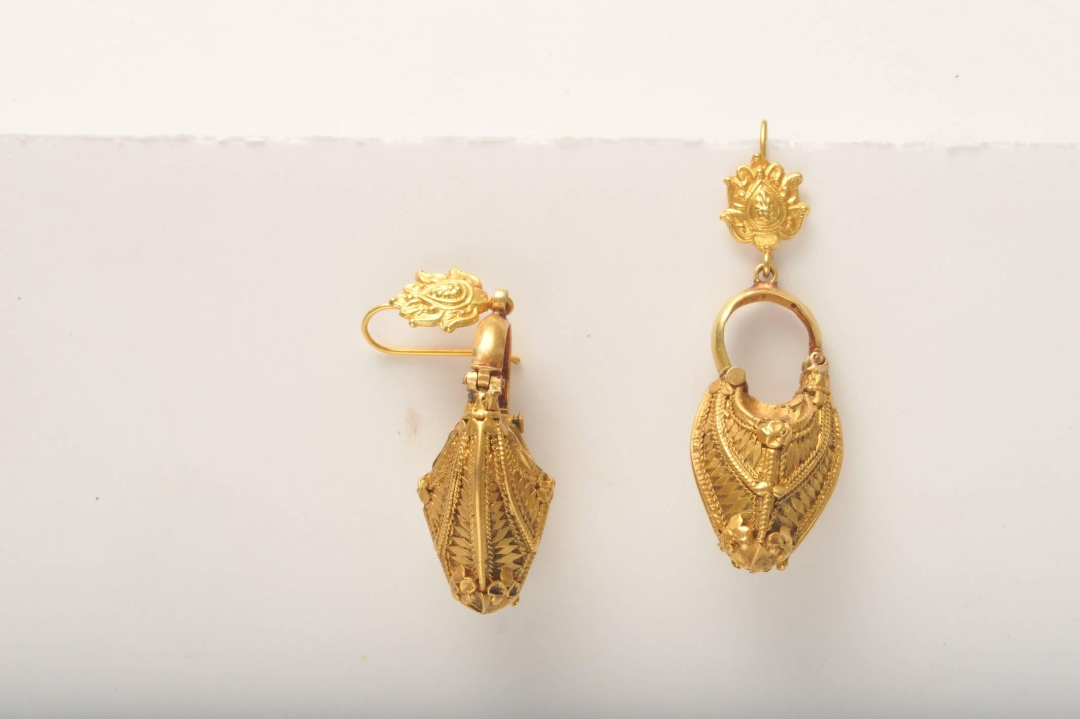 A rare and exquisite pair of antique 22K gold Indian jewelry earrings.  Incredible craftsmanship with fine tooling and granulation work.  Earring wire at top is more recently added which is also nicely detailed.  