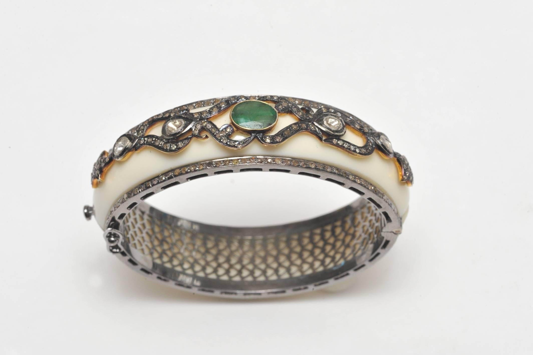 Oval shaped bakelite bracelet bordered in pave`set diamonds along both edges set in oxidized sterling silver.  Set on top of the bracelet is an oval shaped, faceted emerald (1.51 carats) along with rose cut diamonds and pave`set diamonds.  Total