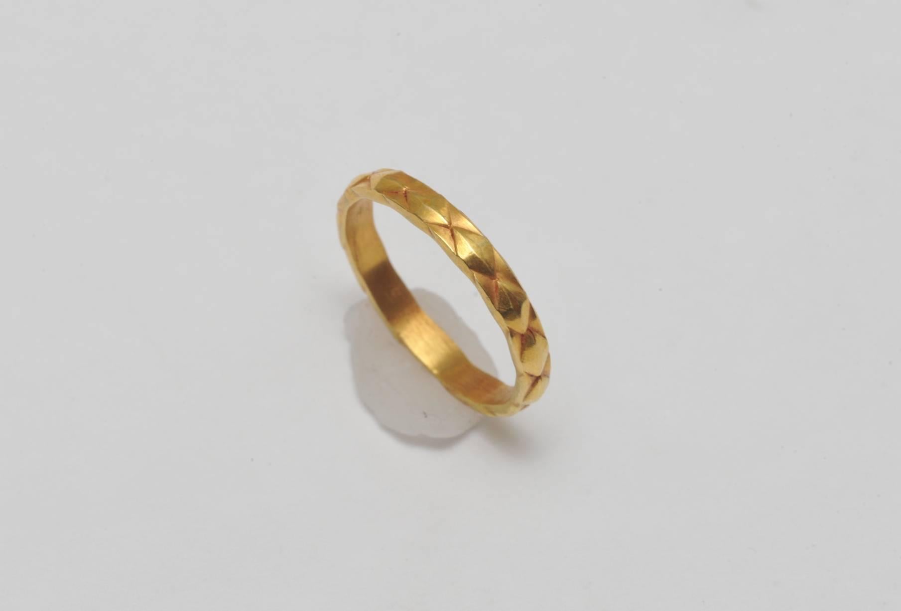 Unusual 18K gold band with textured diamond-shape detail all around.  Ring size is between 5 3/4 and 6.  