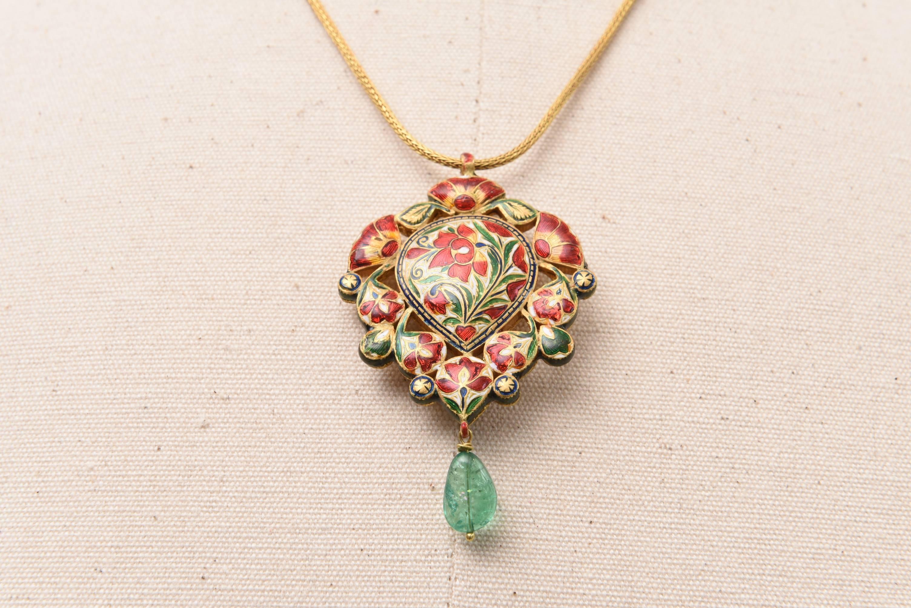 This magnificent pendant represents the Nava Ratna (see below) with precious and semi-precious stones set in 22K gold, and rosecut diamonds encircling the pear-shaped cabochon ruby in the center.  Blue enamel along the outer edge and intricate
