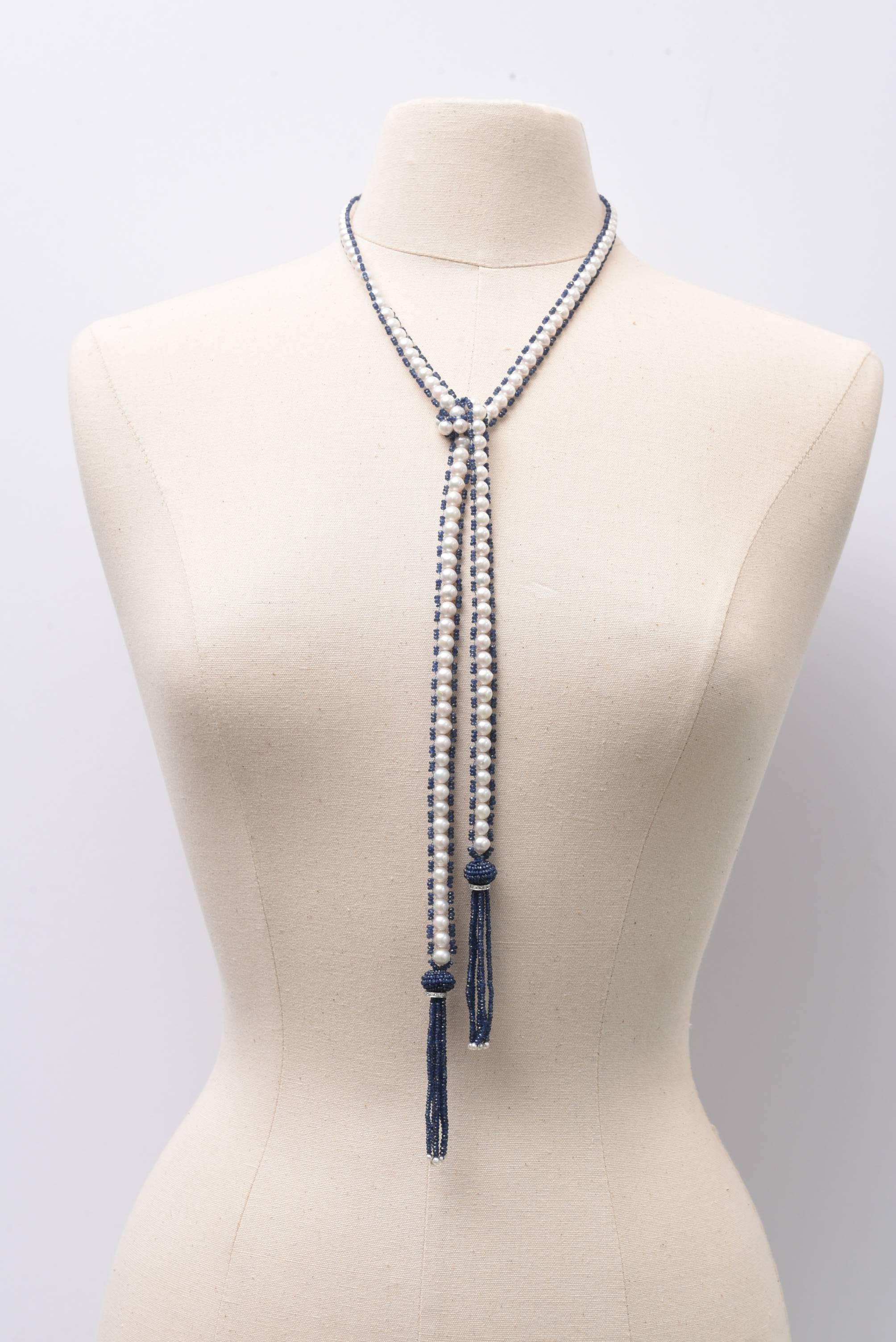 A fabulous and versatile lariat of fresh water pearls bordered with faceted blue sapphires with an 18K white gold diamond rondel at the top of the sapphire tassel.  Wear it long or short, wrapped around or clasped with a pin of your choice.   Dressy