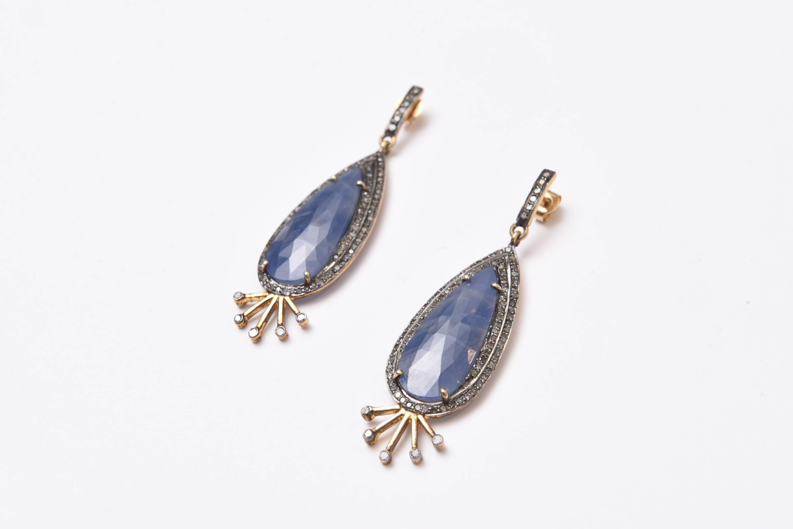 Unusual and elegant pear-shaped, rosecut blue sapphire earrings and diamonds set in sterling silver with 18K gold post.  A double row of pave` set diamonds along the upper half and diamonds at the ends of the radiating rays at the bottom.  Carat