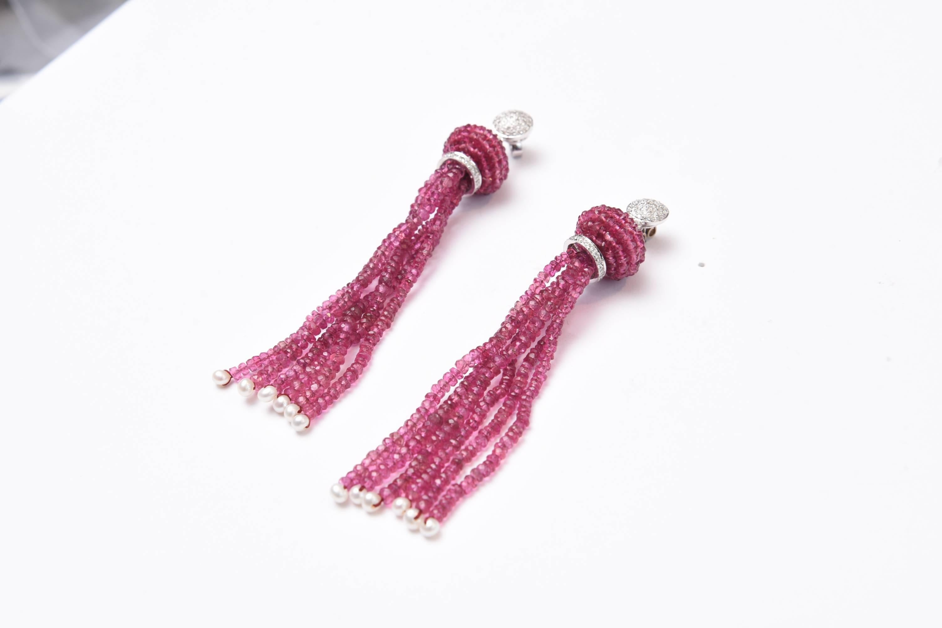 Pair of faceted pink tourmalines with seed pearls at the bottom.  18K white gold and pave` set diamond rondells as well as the top stud which has a 3/8ths inch diameter  Great look and movement.  For pierced ears.