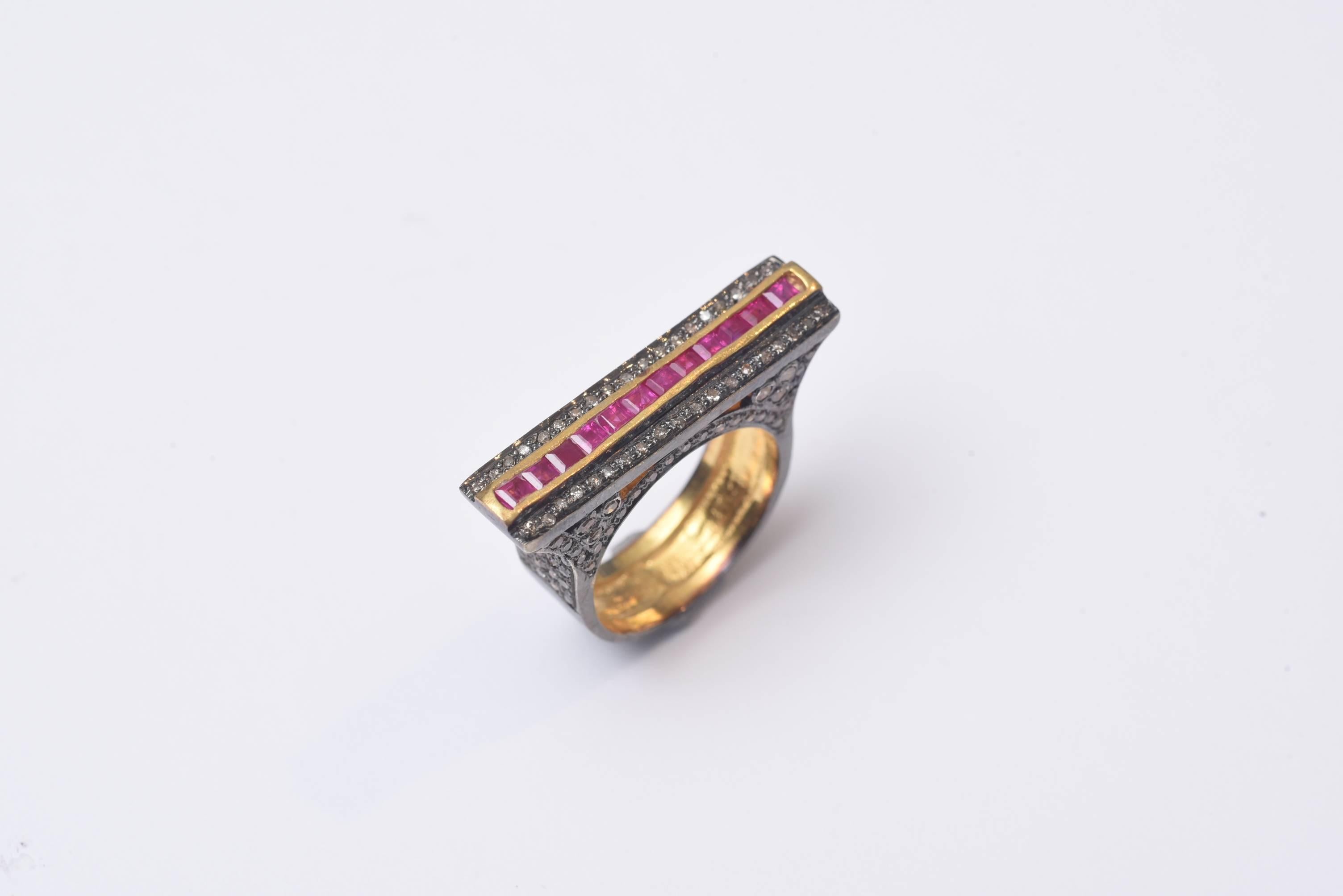 A very unusual setting of channel-set rubies bordered in 18K gold along with a border of pave`set diamonds along the top and the sides of the ring.  Oxidized sterling silver.  Carat weight of diamonds is 1.25; rubies 1.40.  Ring size is 7.