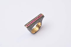 Ring with Channel-Set Rubies and Pave Set Diamonds