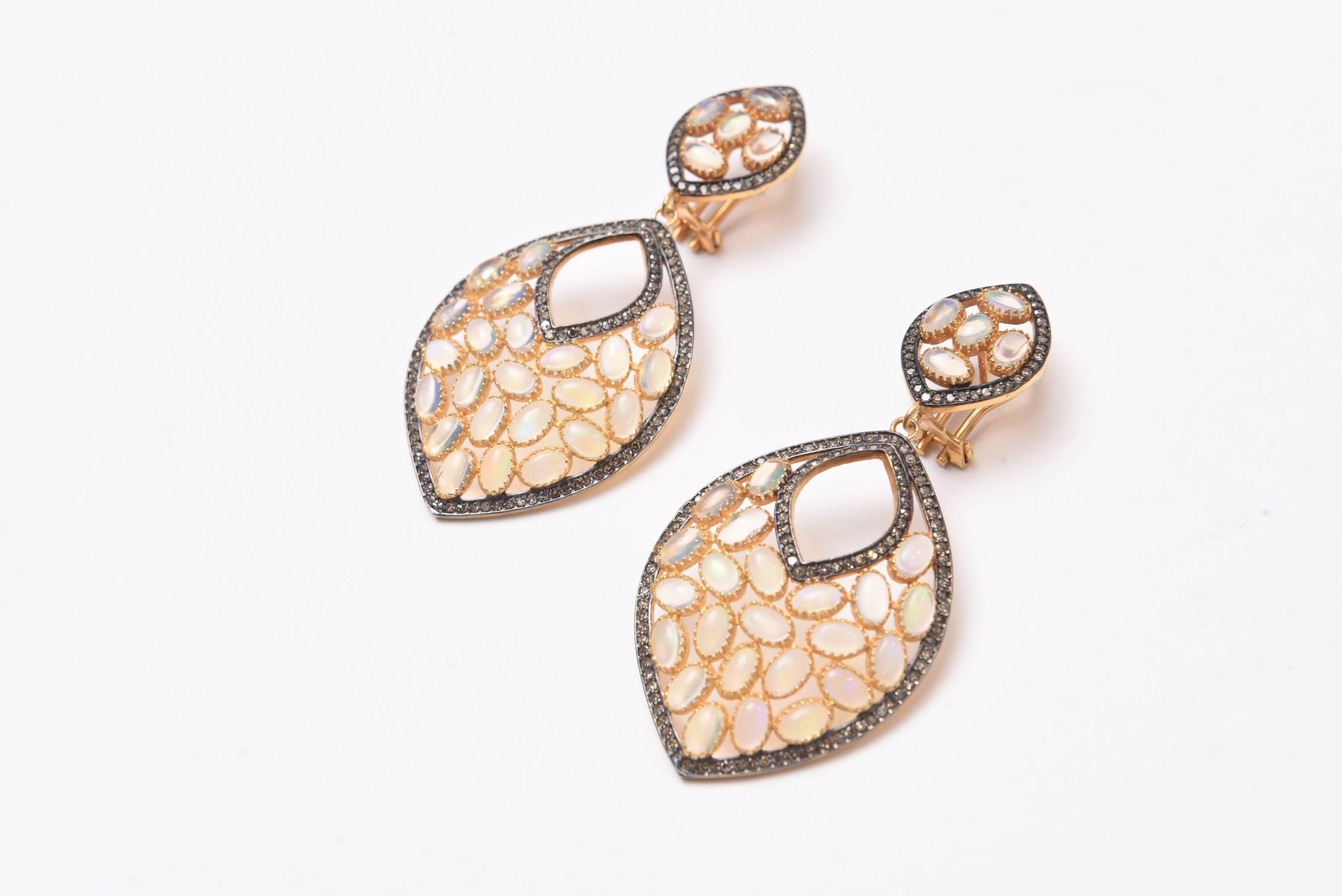 Pair of fabulous opal earrings with nice fire in the stones in a bezel setting and bordered with pave`set diamonds.  18K gold post with omega back for pierced ears, Oxidized sterling and vermeil.  Carat weight of opals is 8.08; diamonds are 1.56