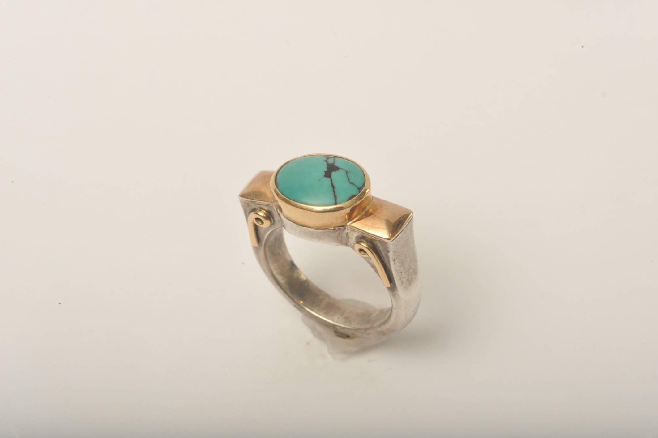 A handsome ring of Tibetan turquoise with matrix set in a weighted (not plated) 18K gold and sterling silver combination.  Ring size is 6.25.