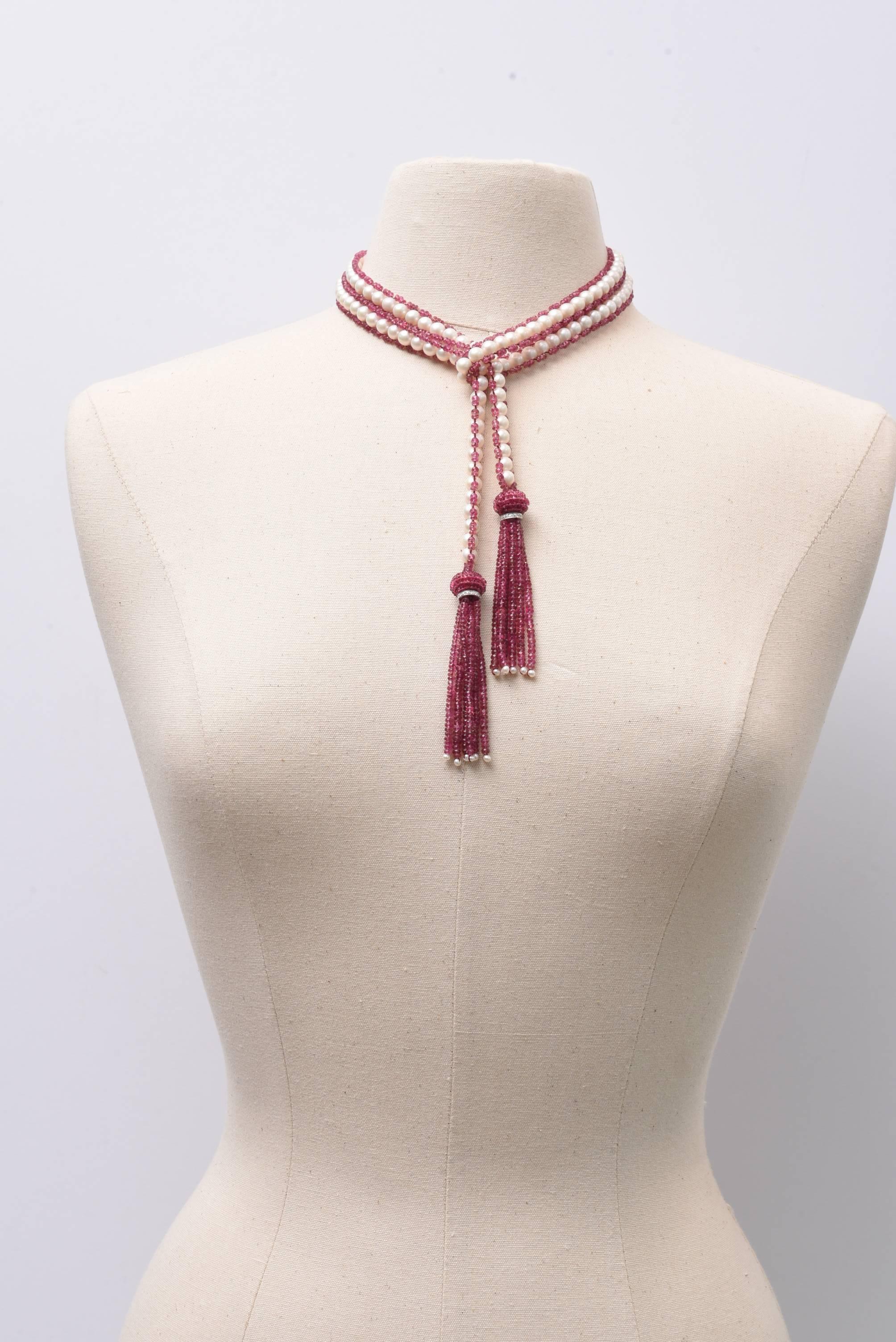 A fabulous and versatile lariat of fresh water pearls bordered with faceted pink tourmalines with an 18K white gold diamond rondel at the top of the tourmaline tassel and seed pearls at the bottom. Wear it long or short, wrapped around or clasped