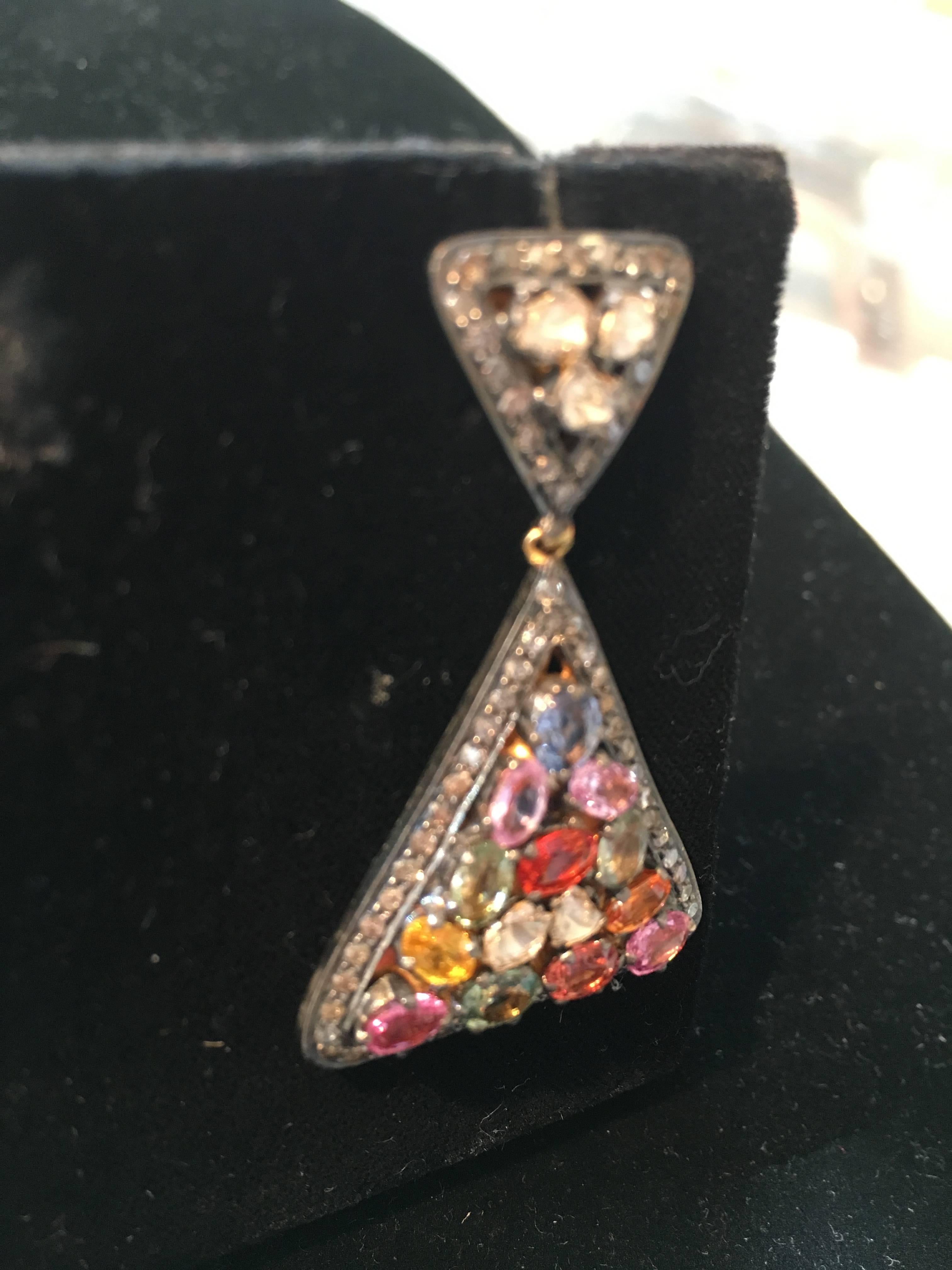 A fabulous mosaic of colored sapphires bordered with diamonds set in an oxidized sterling with an 18K gold post for pierced ears.  Carat weight of sapphires is 3.05.  