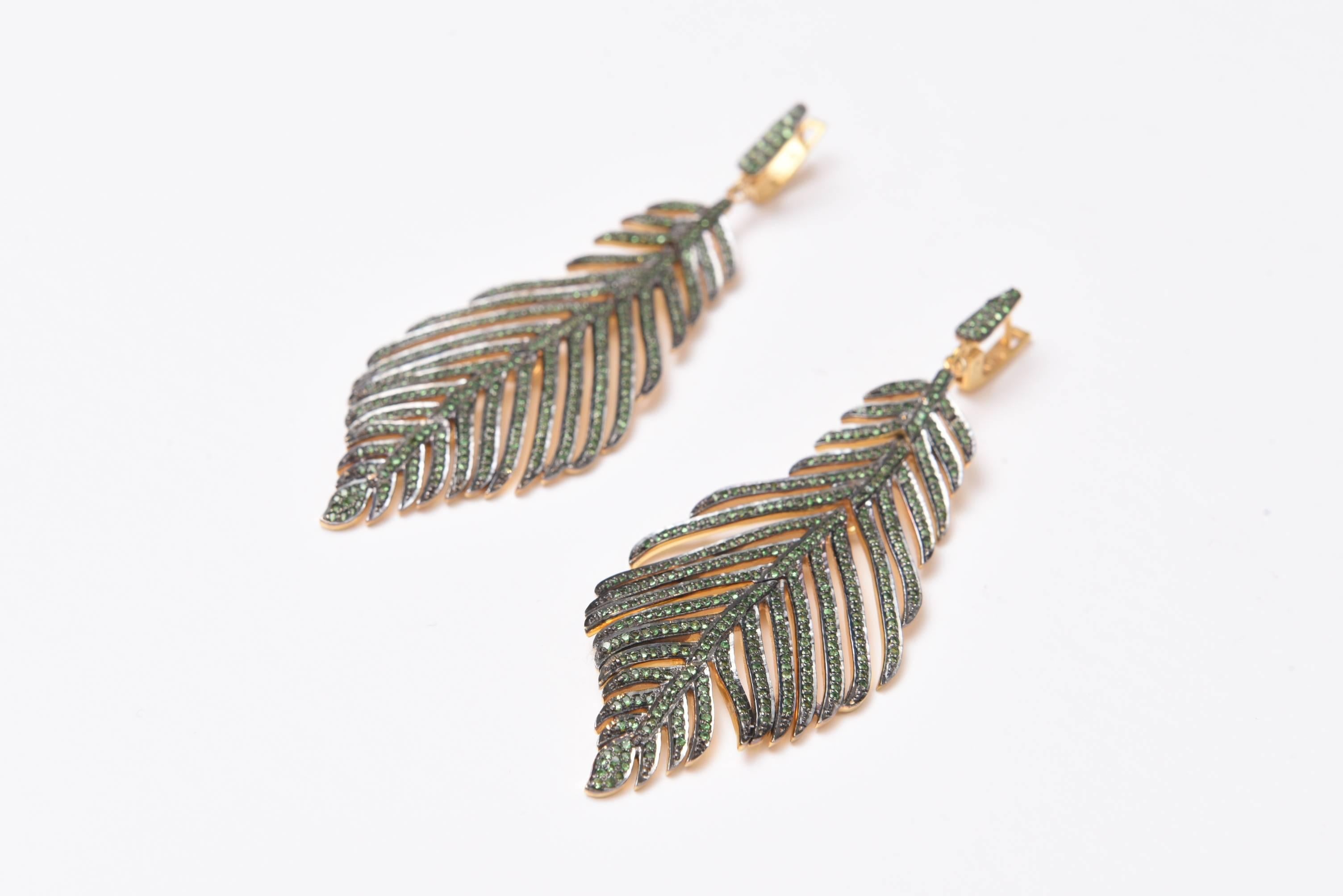 A stunning pair of pave` set tsavorite feather earrings set in vermeil (gold over sterling) with 4 hinge points on the back offering articulated movement when you wear them.  Post is 18K gold for pierced ears with a lever back.  Carat weight of