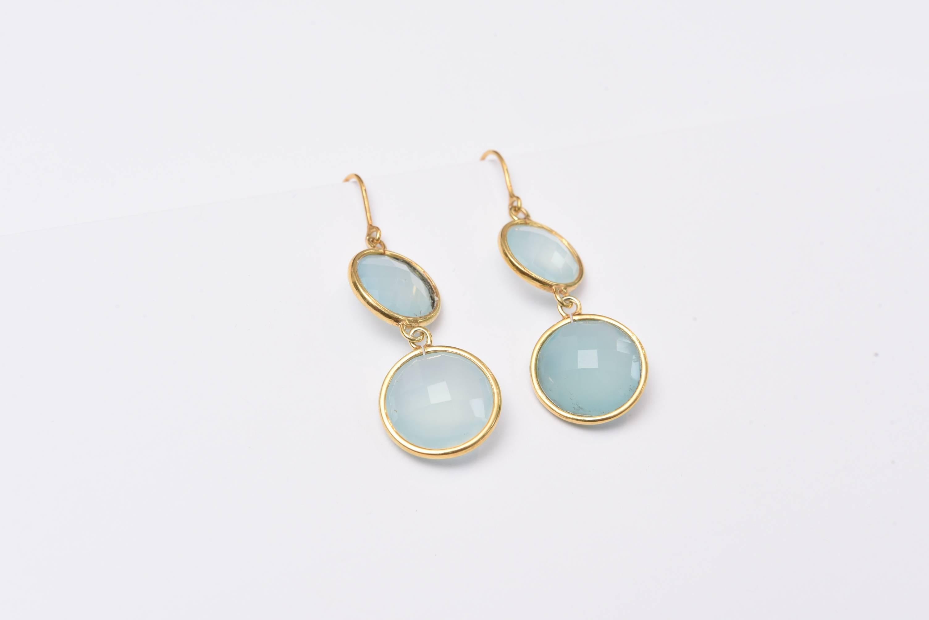 Double drops of double-faceted chalcedony bordered in 18K gold.  One hangs forward and the other sideways offering a nice dimension and movement when worn.  18k French wires for pierced ears.
