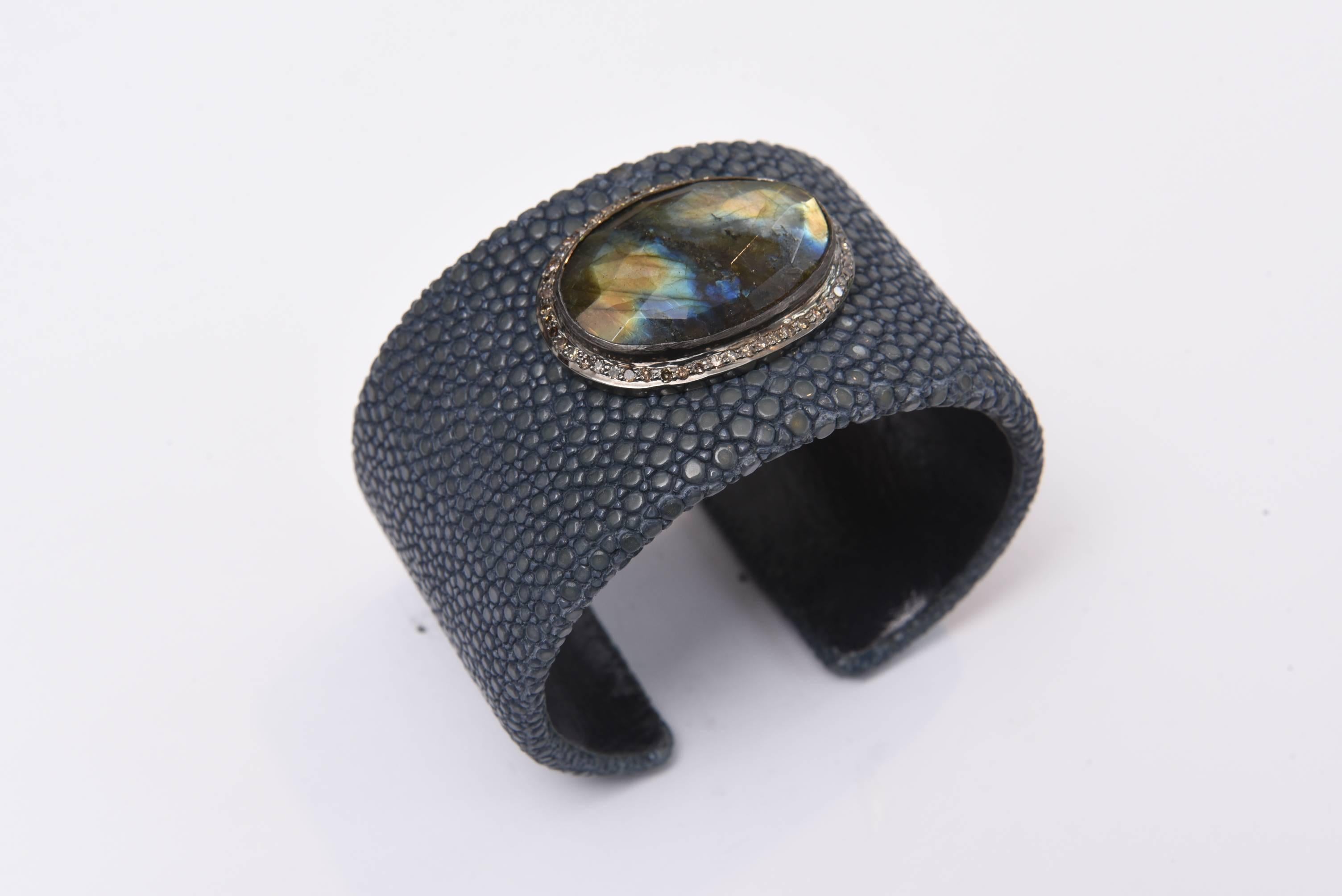 A stunning cuff bracelet made of shagreen (sting ray) in a gray/blue color with a large rosecut labradorite stone on top set in sterling silver with diamonds around the border.  The labradorite has fantastic life and iridescence.  Carat weight of