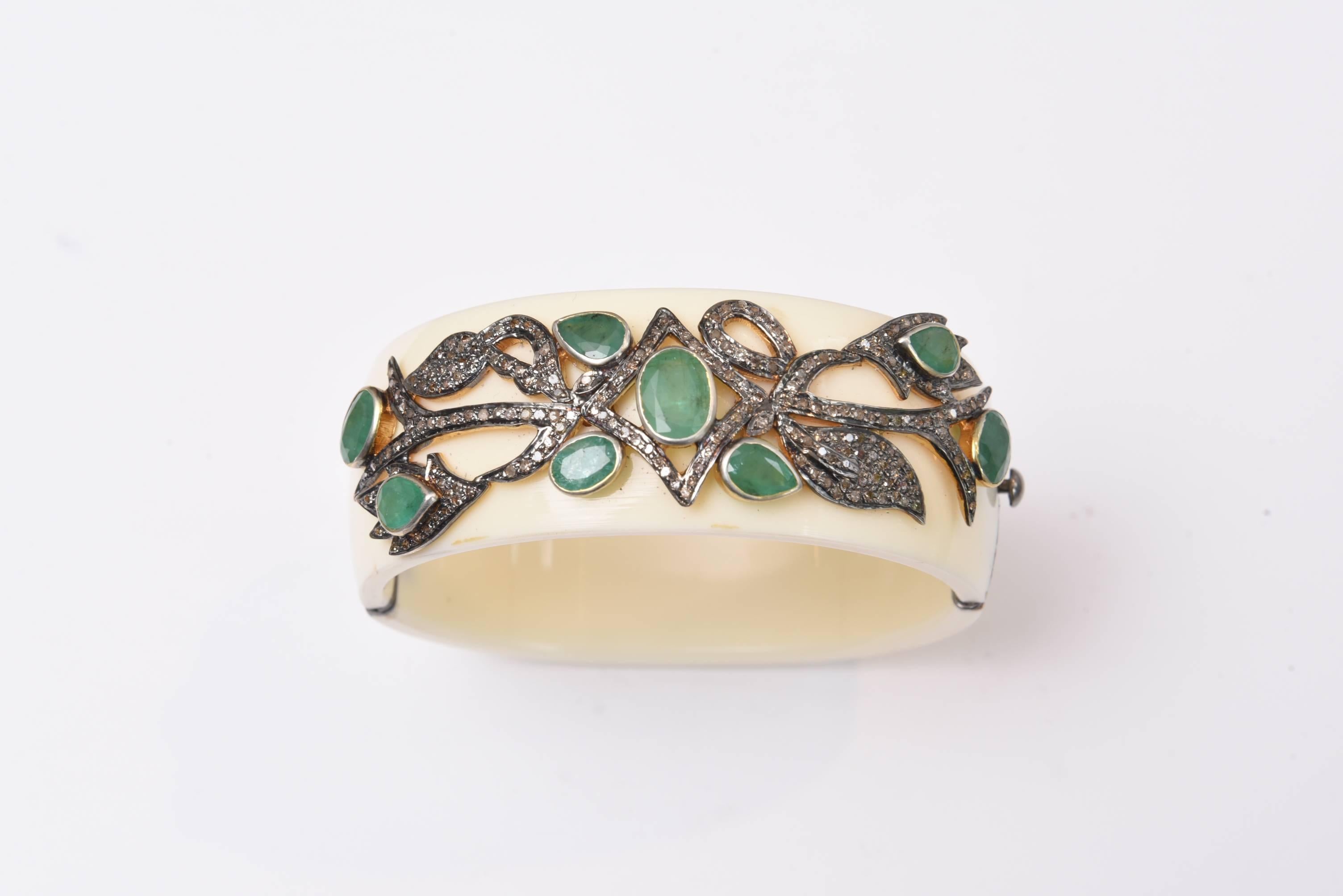 Fabulous Bakelite cuff bracelet with pave` set diamonds and faceted emeralds set in oxidized sterling silver.  Nice oval shape keeps the bracelet from turning over.  Carat weight of emeralds is 7.55 and diamond weight is 1.47 carats.  Push clasp. 