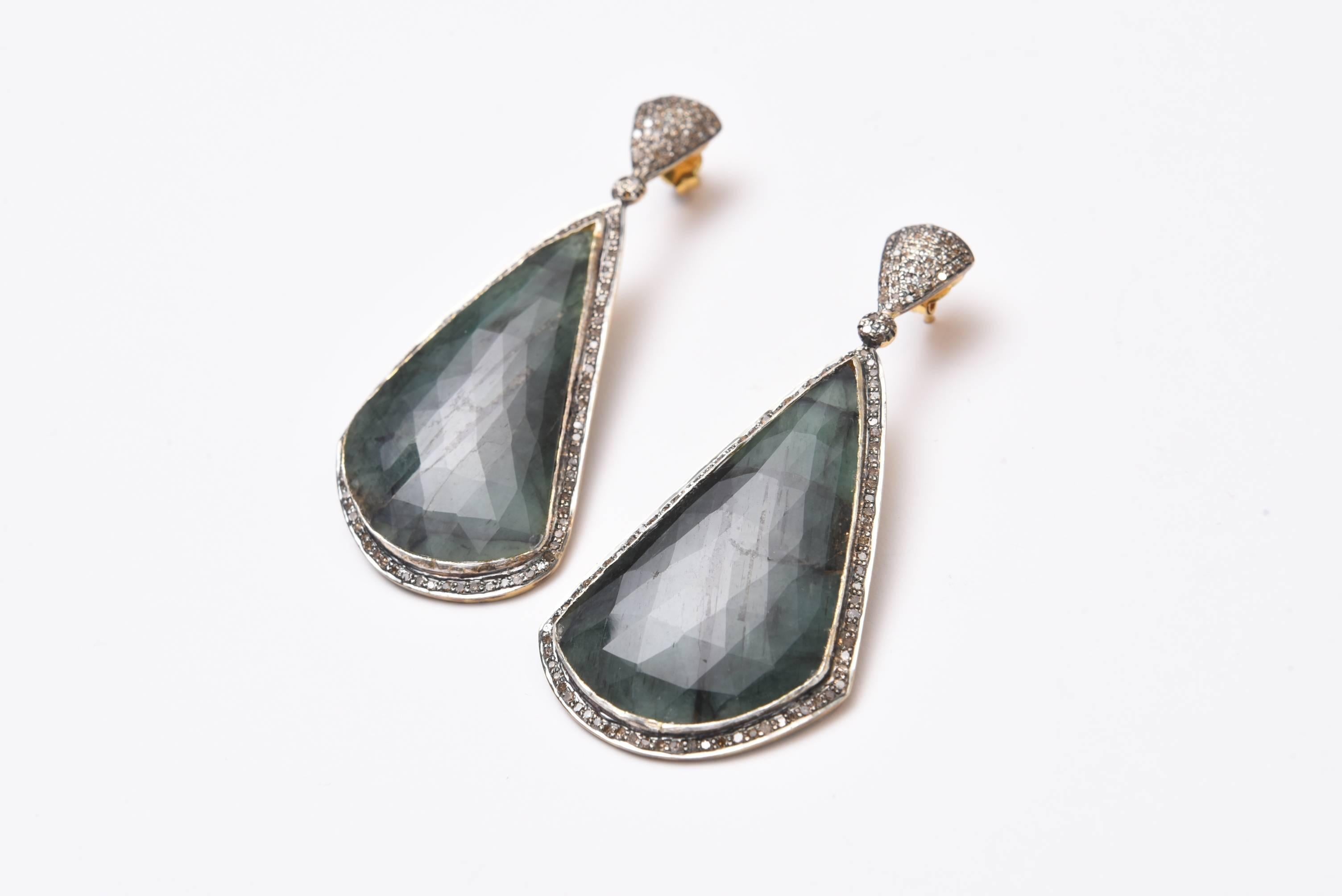 Extraordinary size of rose cut emeralds in their natural state bordered in pave`set diamonds in sterling silver.  Diamonds on the post as well with 18K gold earring posts for pierced ears.  Emeralds are 50.75 carats and diamonds are 1.90 carats. 