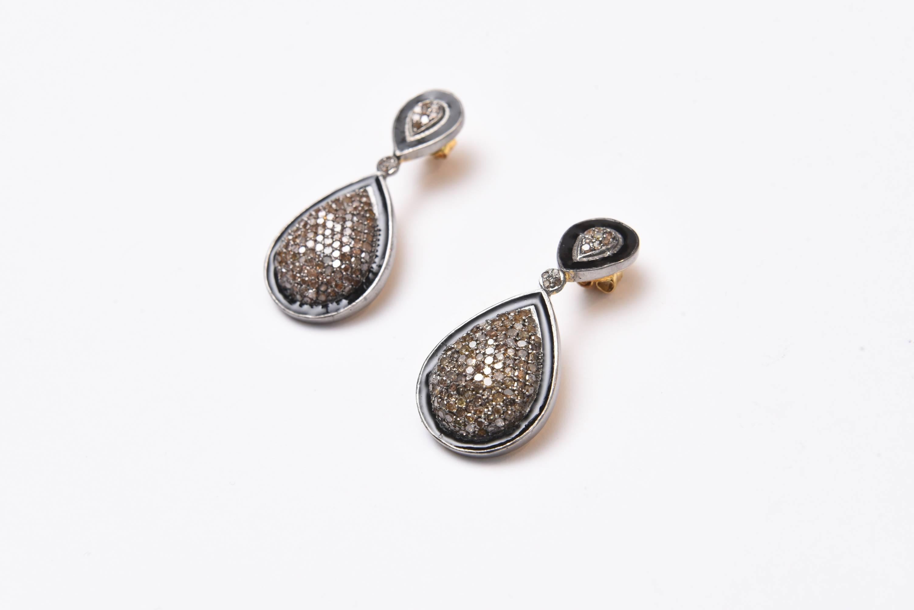 Stunning pair of pave` set diamonds bordered in black enamel set in sterling silver.  Carat weight of diamonds is 3.60.  18K gold post for pierced ears.