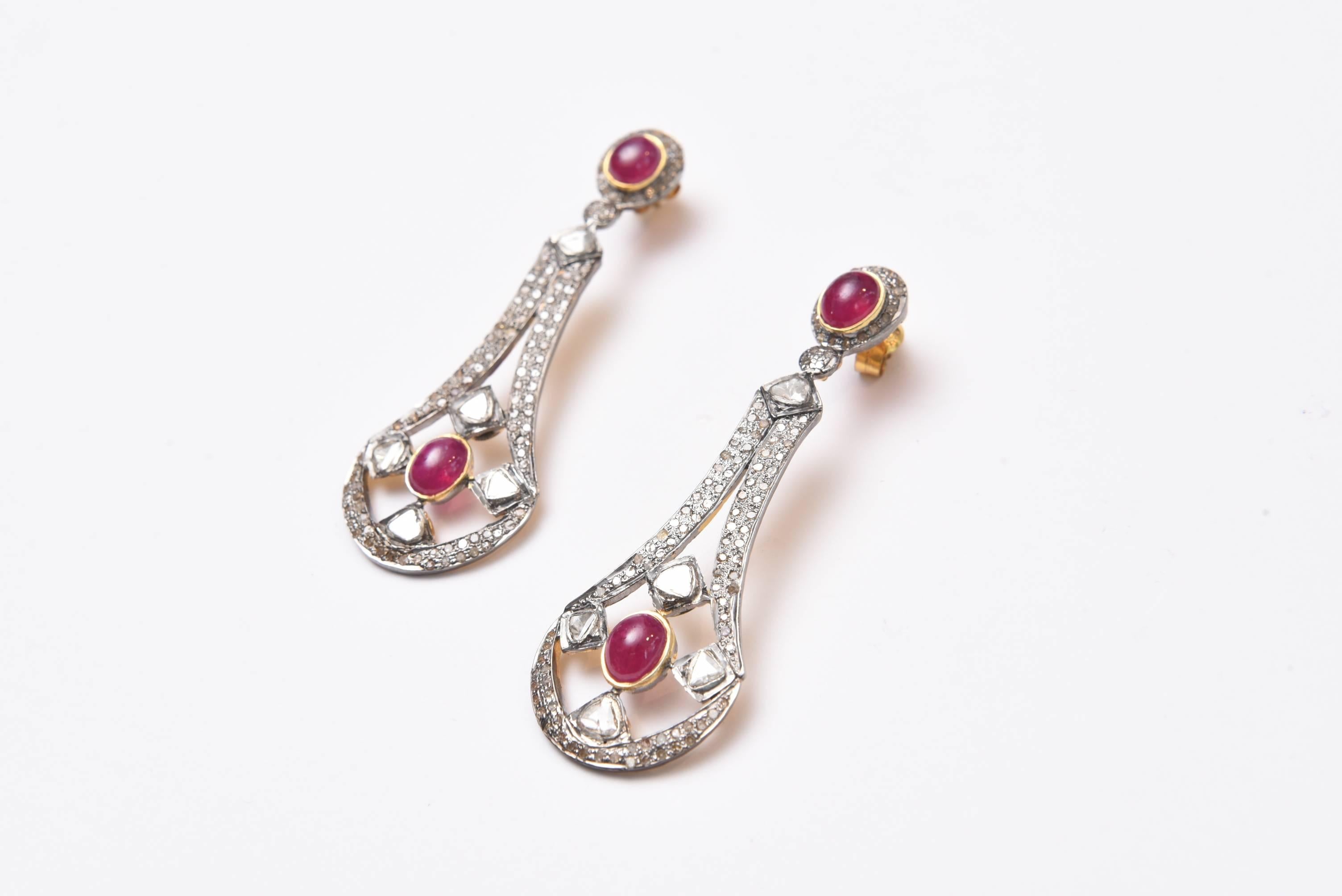 Fantastic pair of drop earrings featuring large cabochon rubies set with rosecut and pave` set diamonds in sterling with 18K gold post.  Carat weight of rubies is 8.4 and diamonds are 2.35 carats.  For pierced ears.