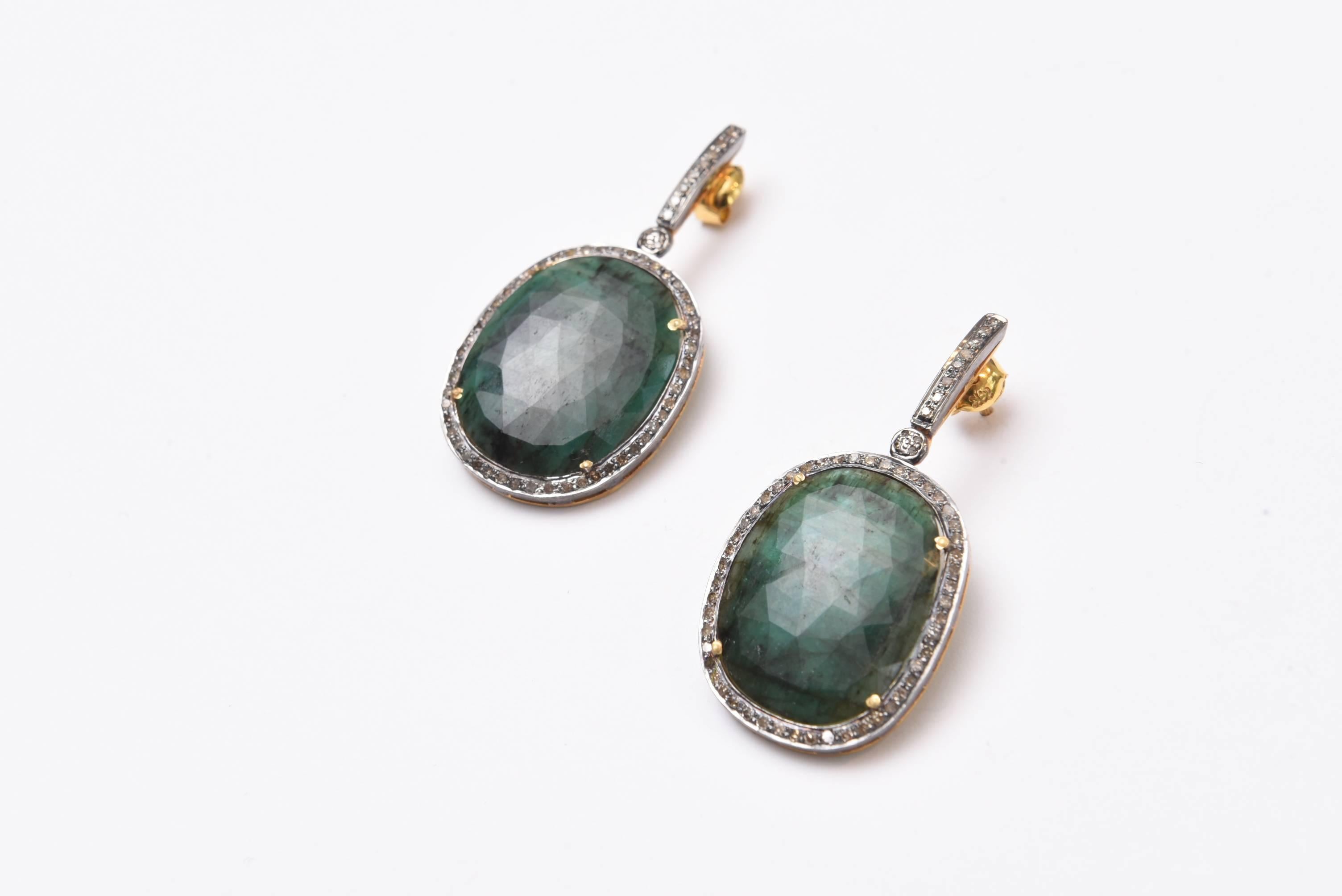 Rosecut emerald slices bordered in pave`-set diamonds set in an oxidized sterling silver with diamonds on the elongated post.  Carat weight of emeralds is 50.75.  These are emeralds in their natural state and polished.  Diamond weight is 1.10