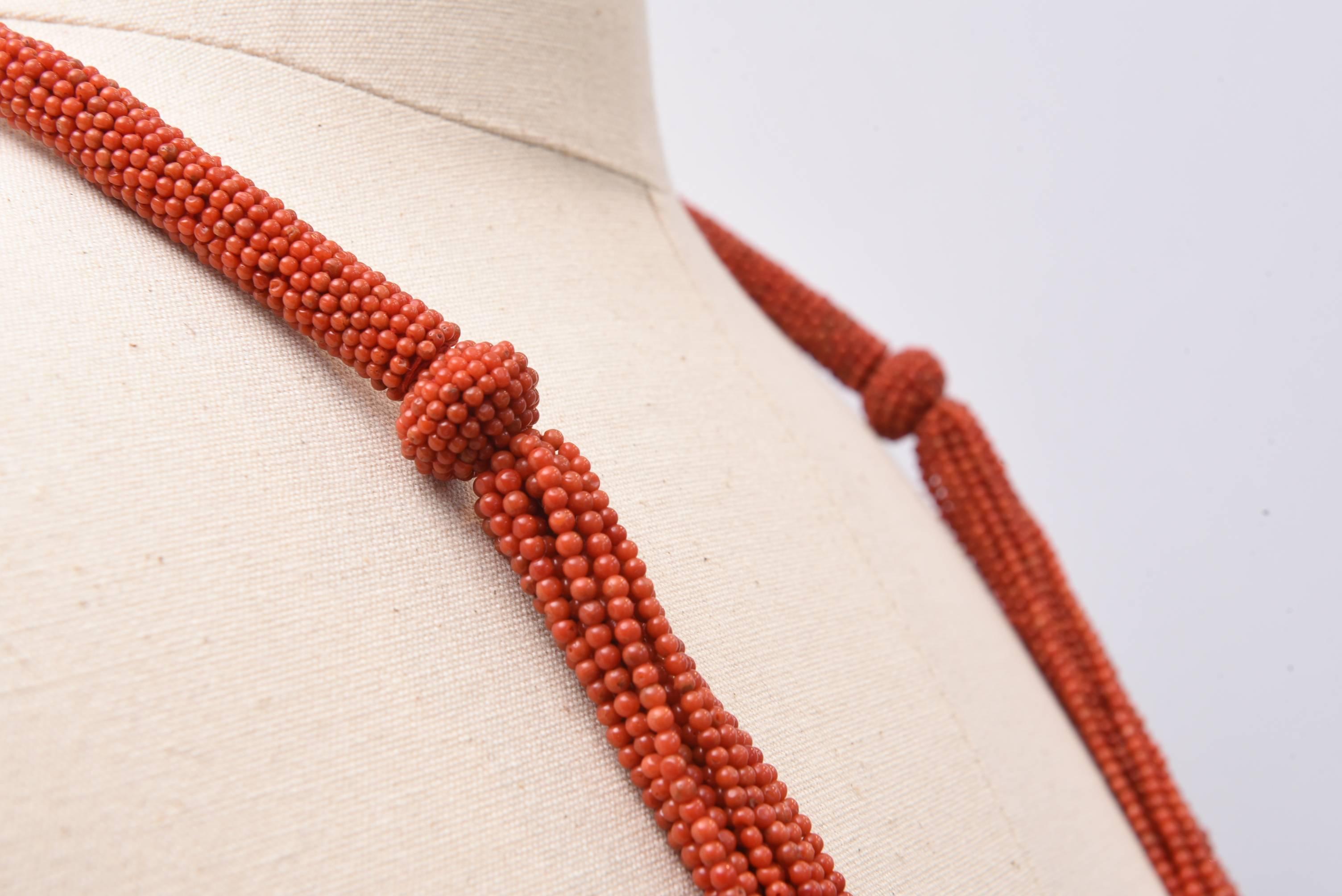 Hand-beaded 18 strand coral necklace with woven beads at collar bone and along the back.  Great length.  Length of just the strands is 21 inches.  Overall length is 36 inches.

The Lockhart Collection
Nantucket