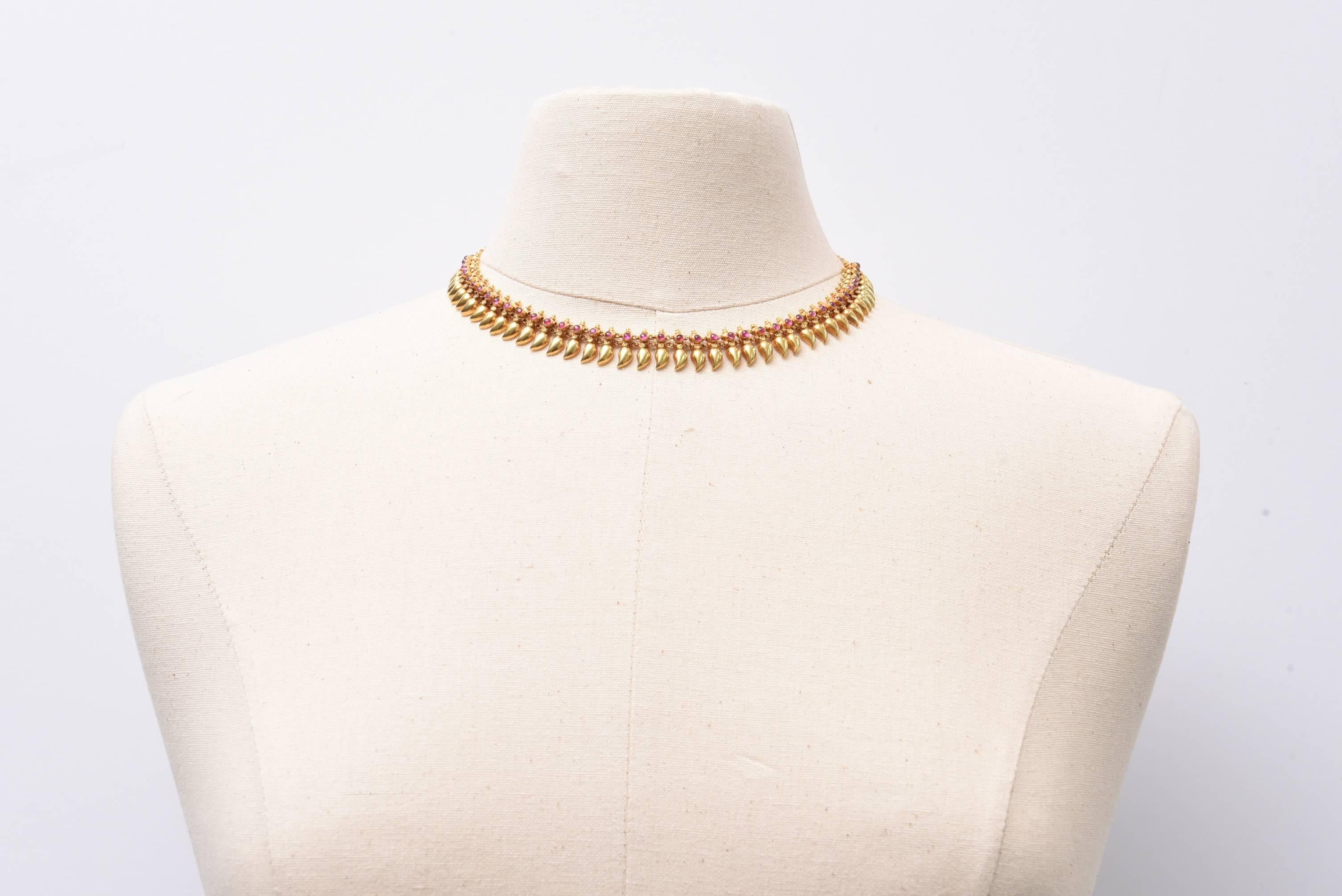Exquisite 22K gold necklace with cabochon rubies.  Nice on an open neckline or inside a button down shirt.  Links at the back allow for some adjust-ability.  Length range is 15 inches to 16.5 inches.  Lovely granulation work on the gold.   Elegant