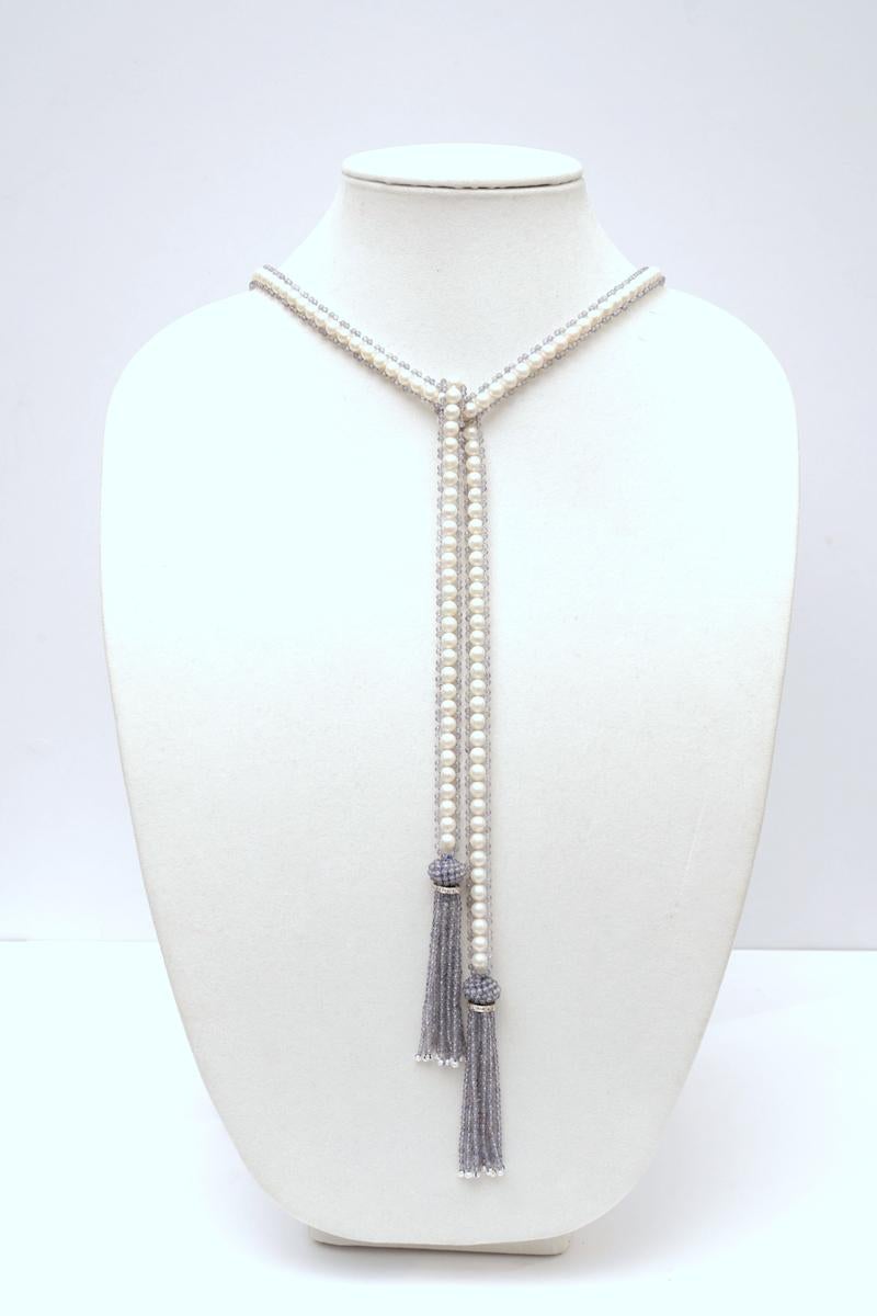 Fresh water white pearls bordered with faceted iolite beads finished with an iolite cluster with 18K white gold rondelle and a tassel of faceted iolite with seed pearls at the bottom.  A very versatile piece, this can be worn long or short.  A