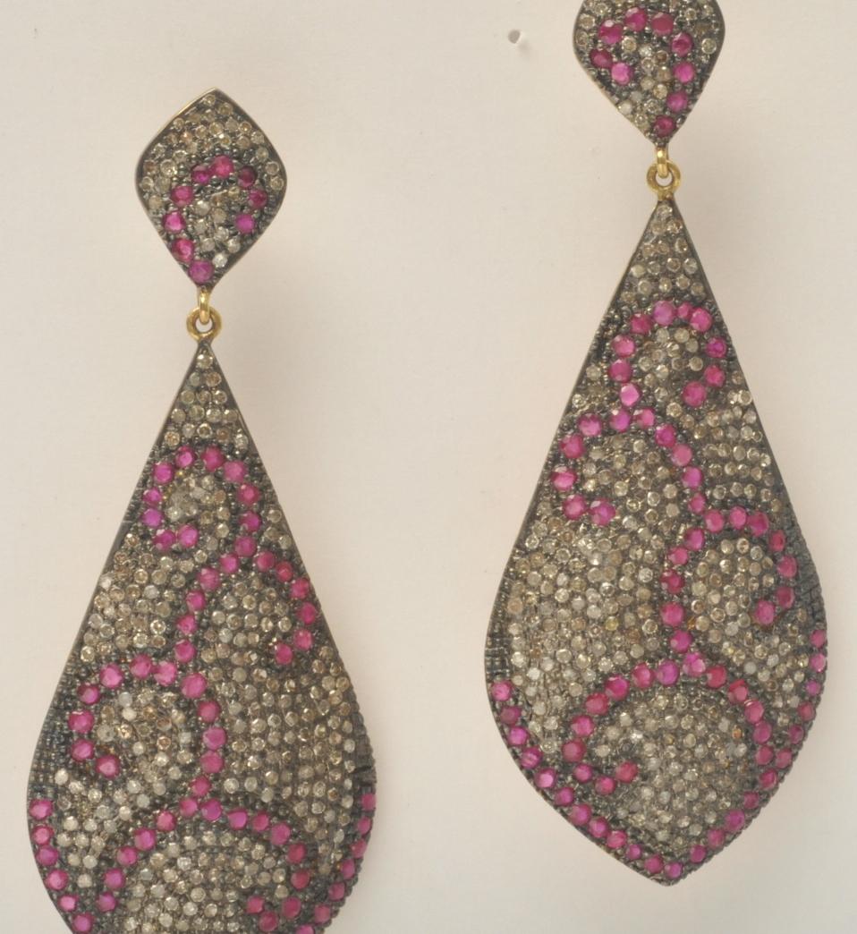 Fabulous coral-design earrings of pave` set diamonds and rubies set in ozidized sterling with an 18K gold post for pierced ears.

3.60 carots of diamonds; 5.36 carats of rubies

Located on Nantucket Island
