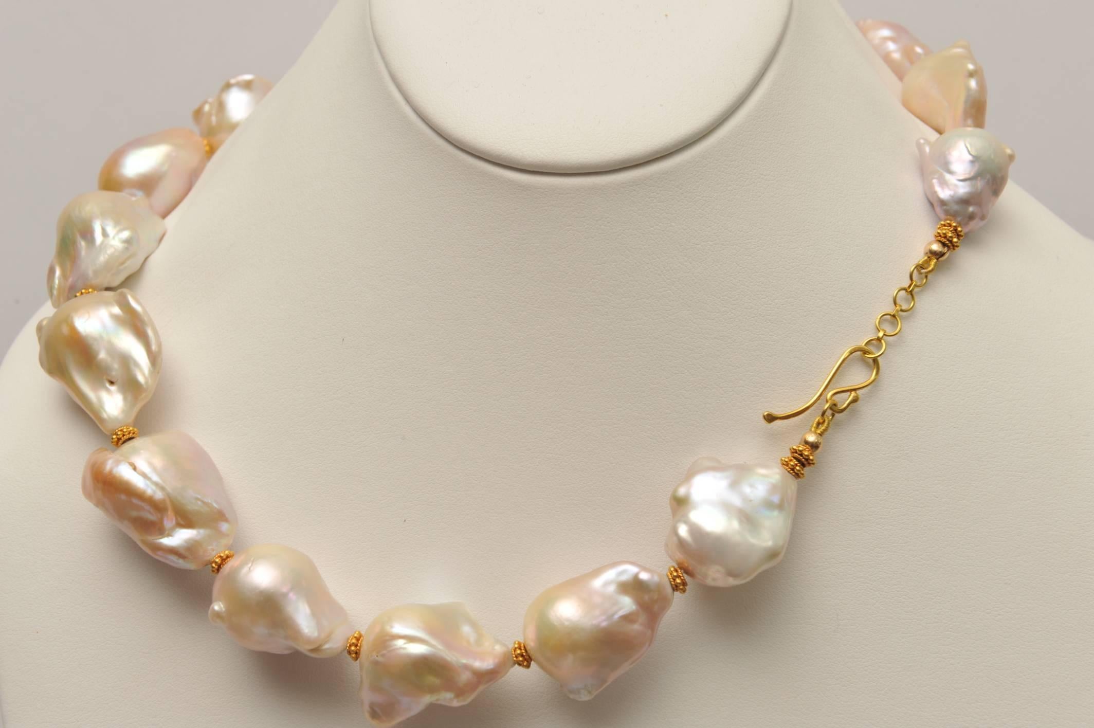 A beautiful strand of 22-30mm, rare blush pink baroque pearls with incredible luster strung with 22K gold spacers with fine granulation work and adjustable length with 3/4