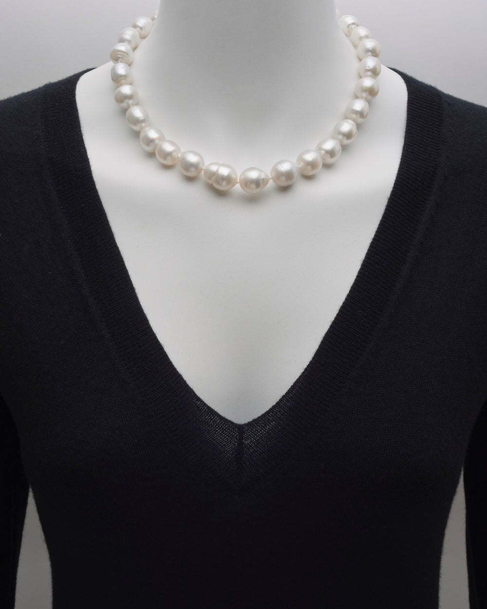 Graduated cultured baroque pearl necklace, composed of 28 pearls measuring approximately 12.5 to 15mm in diameter, secured by a pearl plunger-style clasp in 18k white gold, the clasp signed Seaman Schepps. 18