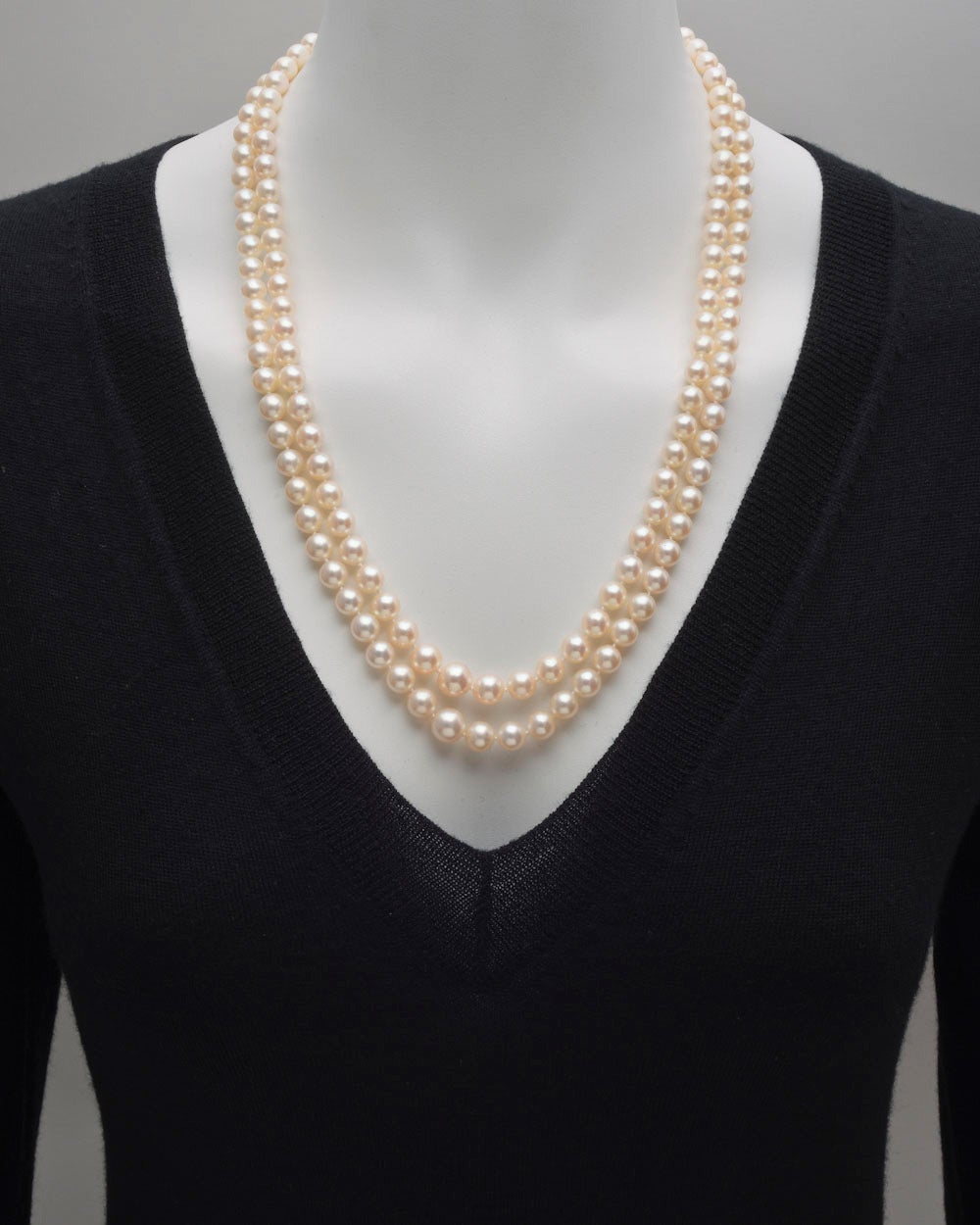 Two-strand graduated cultured pearl long necklace, composed of pearls measuring 5.5 to 9.5mm in diameter, secured by a round and square-cut diamond-set rectangular-shaped clasp in platinum, numbered 3899, signed Tiffany & Co. Strands measuring