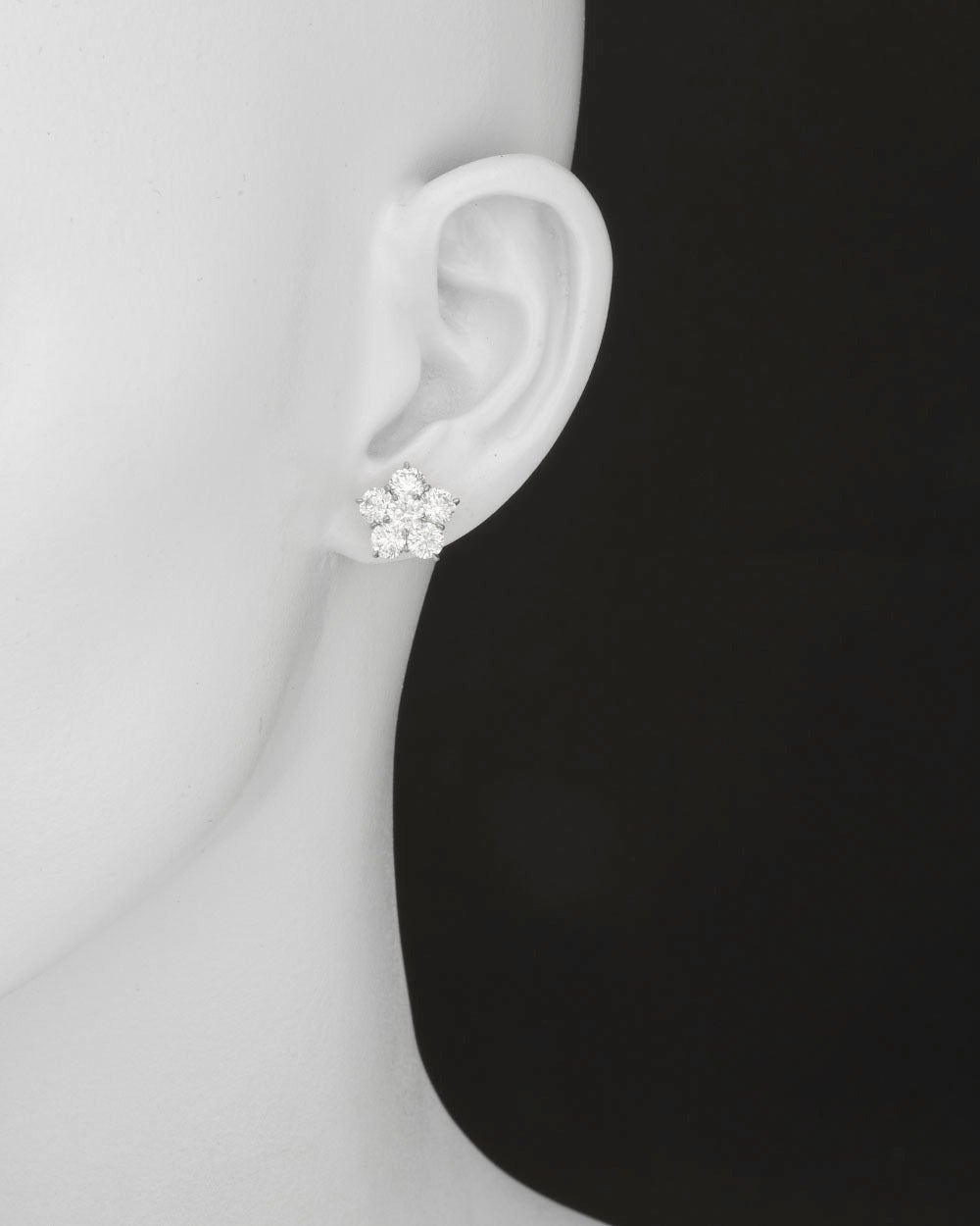 Diamond flower cluster earstuds in platinum. Twelve matching, colorless round brilliant cut diamonds weighing 4.44 total carats, prong-set in platinum with posts and 