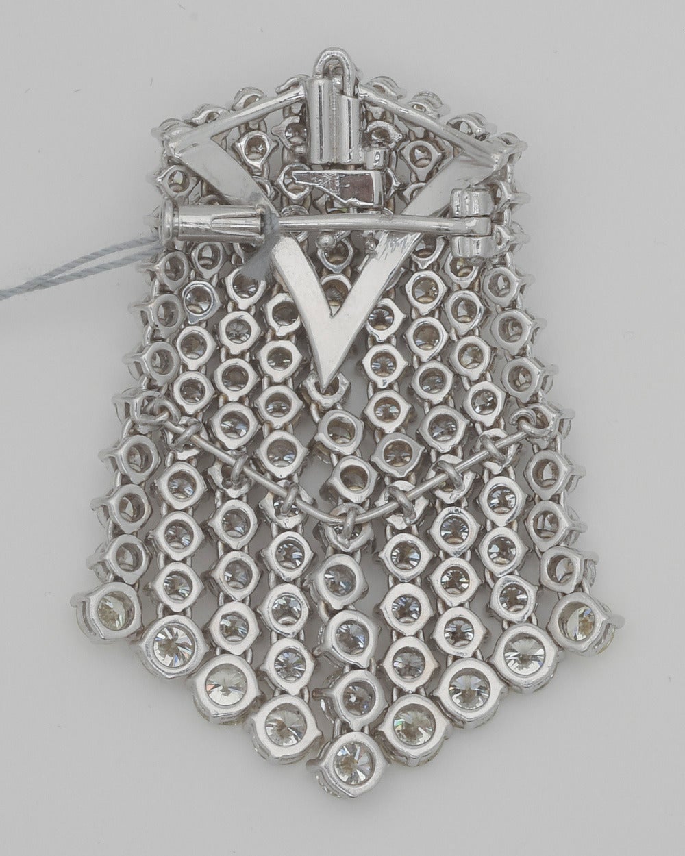 Diamond waterfall pendant brooch, showcasing rows of near-colorless graduating round diamonds each ending in a light yellow colored diamond, the upper portion of each diamond row fixed and lower portion designed as a flexible tassel, with 115