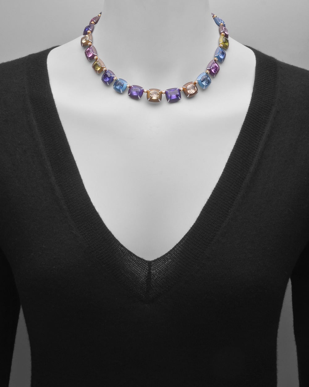 Multicolored sapphire necklace in titanium and 18k gold with diamond accents. 21 cushion-cut natural sapphires, ranging in color from royal blue to brilliant pink, weighing 49.70 total carats with 390 round diamonds weighing 3.17 total carats.