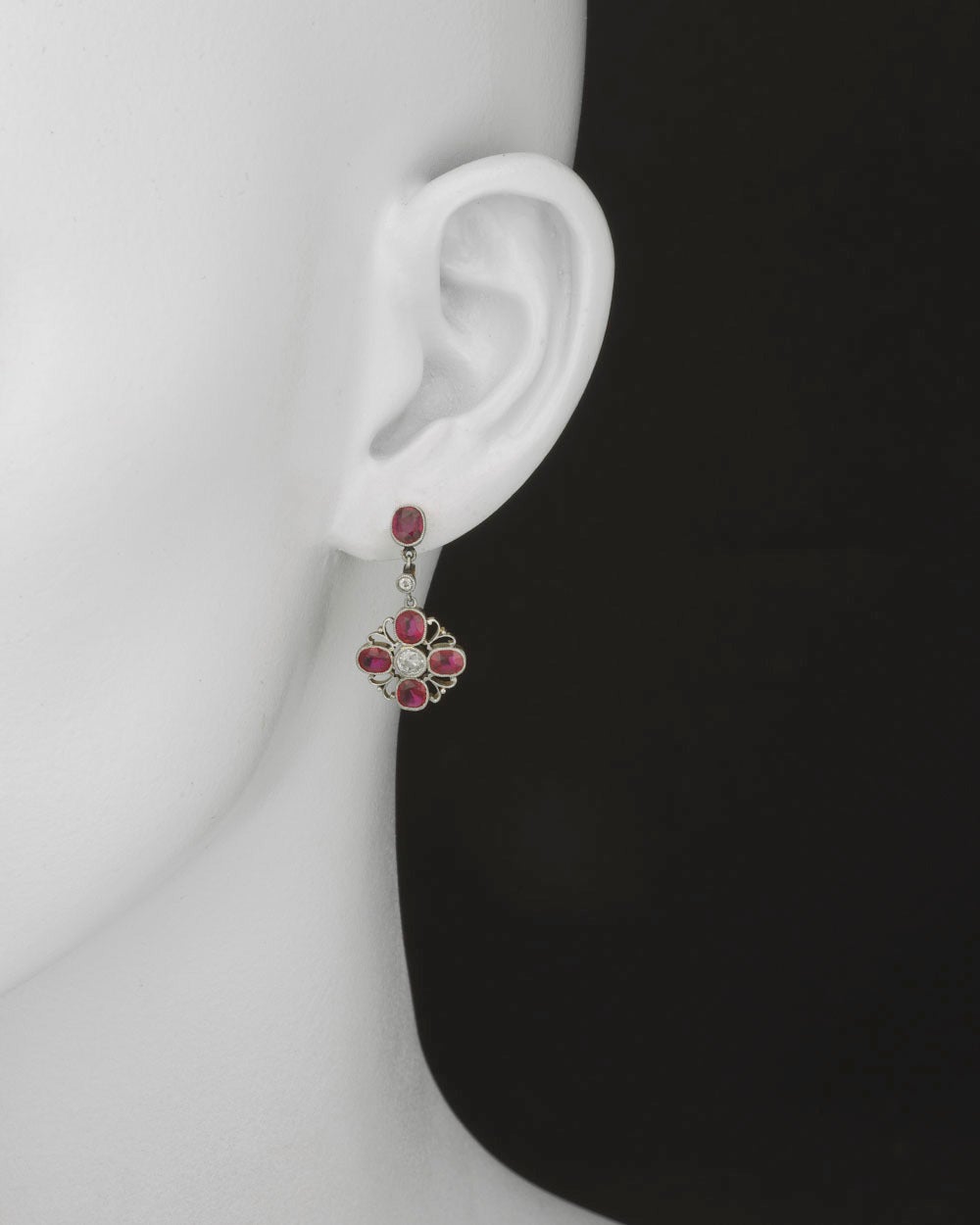 Ruby and diamond pendant earrings, designed as a pierced quatrefoil motif centering on a circular-cut diamond surrounded by four oval-shaped rubies, with an oval-shaped ruby and circular-cut diamond surmount, with ten rubies weighing approximately