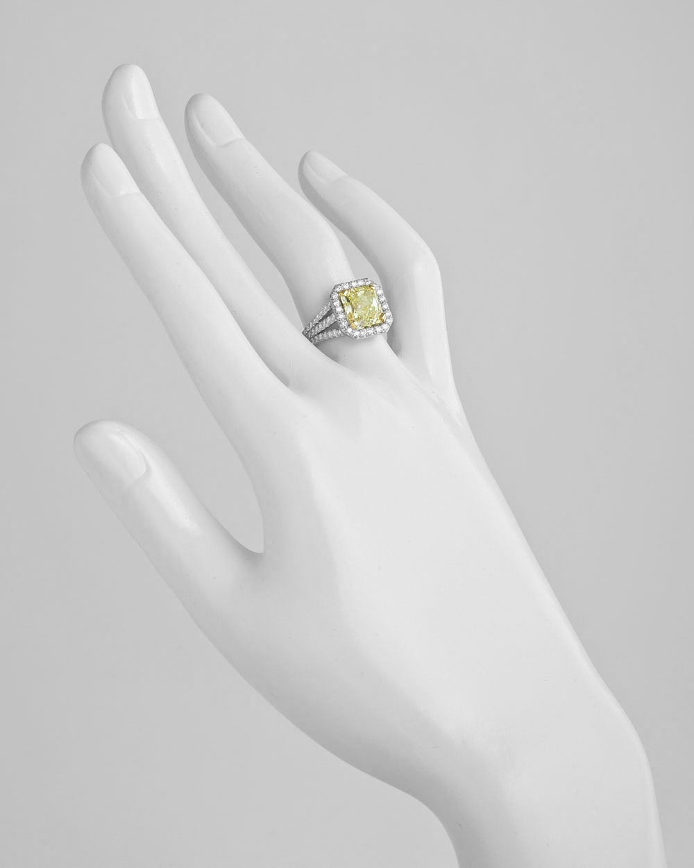 Diamond ring, centering on a natural radiant-cut fancy yellow diamond weighing 3.37 carats, with pavé diamond triple split shank mounting in platinum with an 18k yellow gold central basket. 88 round diamond accents weighing 0.84 total carats.
