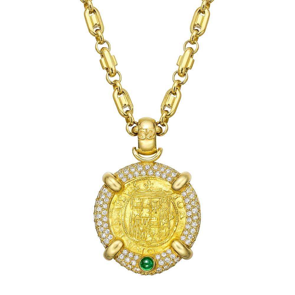 Pendant necklace, showcasing an historic Spanish gold coin within an 18k yellow gold frame pavé-set with full-cut round diamonds and accented by a single cabochon-cut emerald, the pendant suspended from a 19