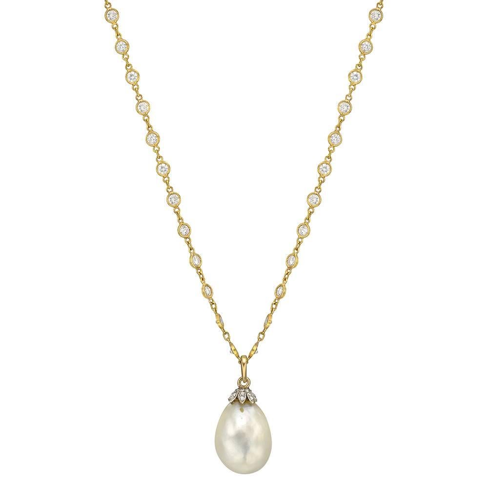 Fine natural pearl and diamond pendant, the light cream-colored natural pearl drop measuring approximately 10.70-14.35 x 19.10mm, weighing 79.98 grains, and capped by rose-cut diamonds in platinum and gold, the pendant suspended from a 16