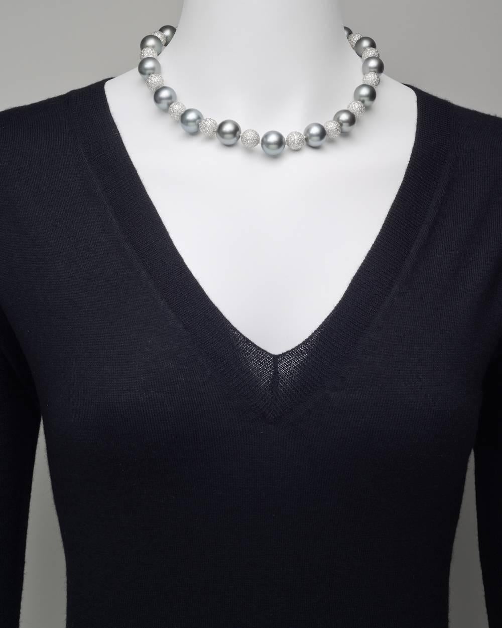 Tahitian pearl and pavé diamond ball necklace, composed of seventeen fine Tahitian pearls ranging from 13.3-14.8mm in size with 29.55 total carats of round brilliant cut diamonds, and strung on a hand-knotted silk cord with a hidden screw-in ball