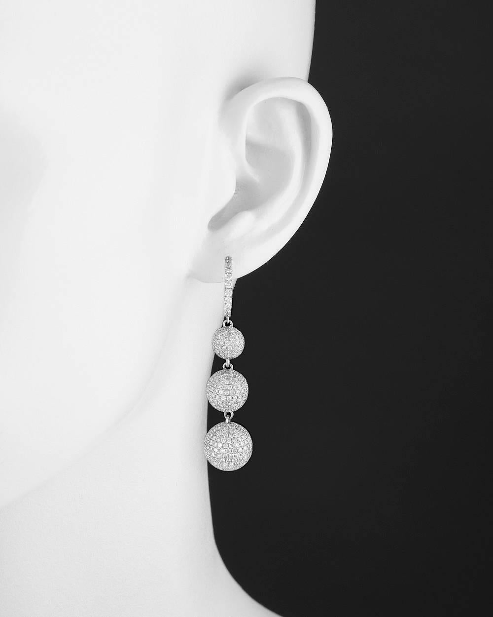 Pavé diamond ball 3-drop earrings, set with round diamonds weighing approximately 9.21 total carats, in 18k white gold, signed Odelia, circa 2007. Snap hoop tops, for pierced ears. 2.15