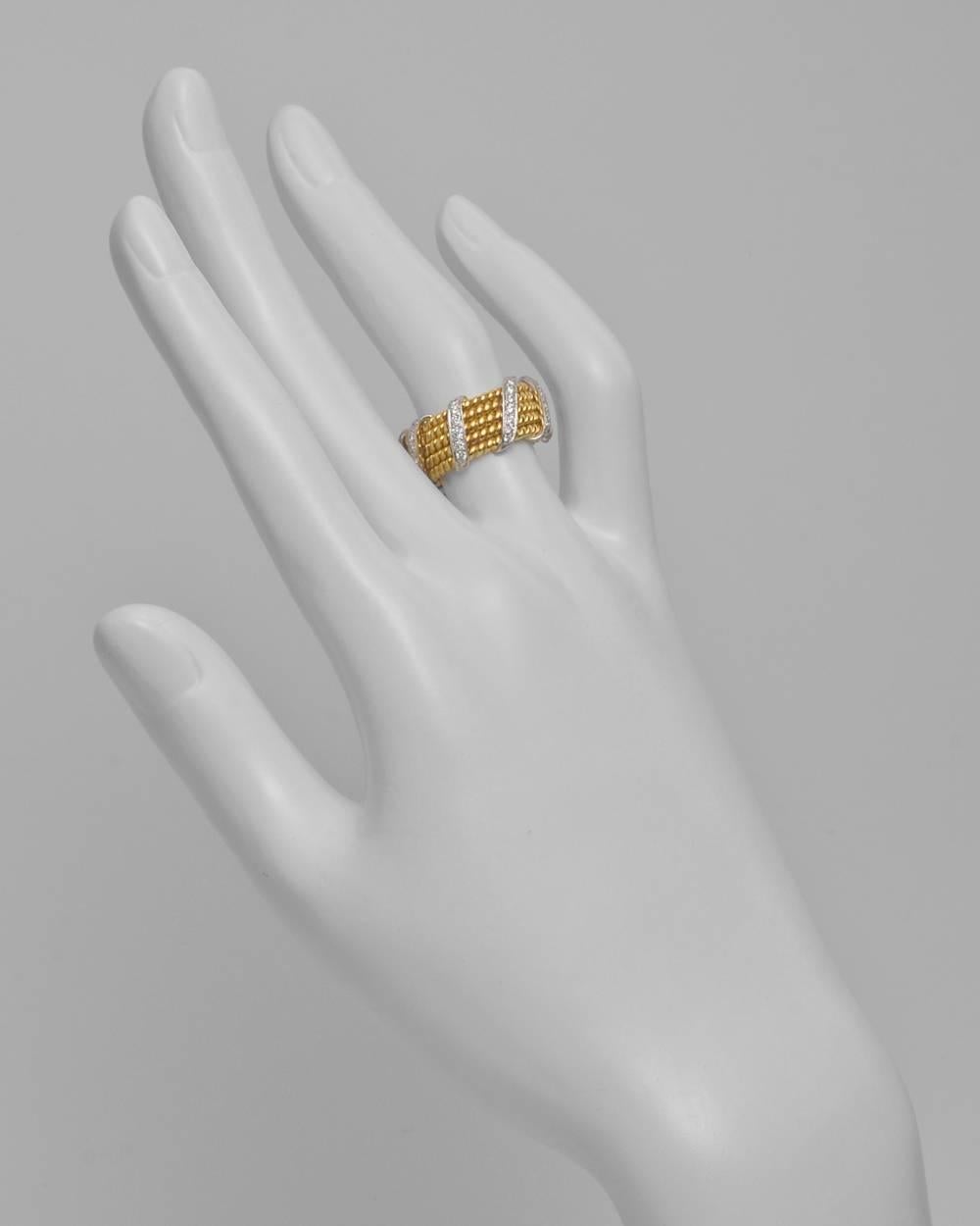Wide band ring, designed with 18k yellow gold twisted in a 5-row rope-patterned band accented by full-cut round diamond-set diagonal wrap bands in platinum, signed Schlumberger for Tiffany & Co. 56 diamonds weighing approximately 0.60 total carats