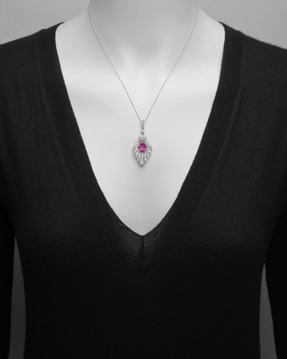 Pink sapphire and diamond pendant, centering a pear-shaped pink sapphire with thirty-one old European-cut and single-cut diamonds, in platinum. Pink sapphire weighing approximately 2.94 carats and diamonds weighing approximately 0.84 total carats (G