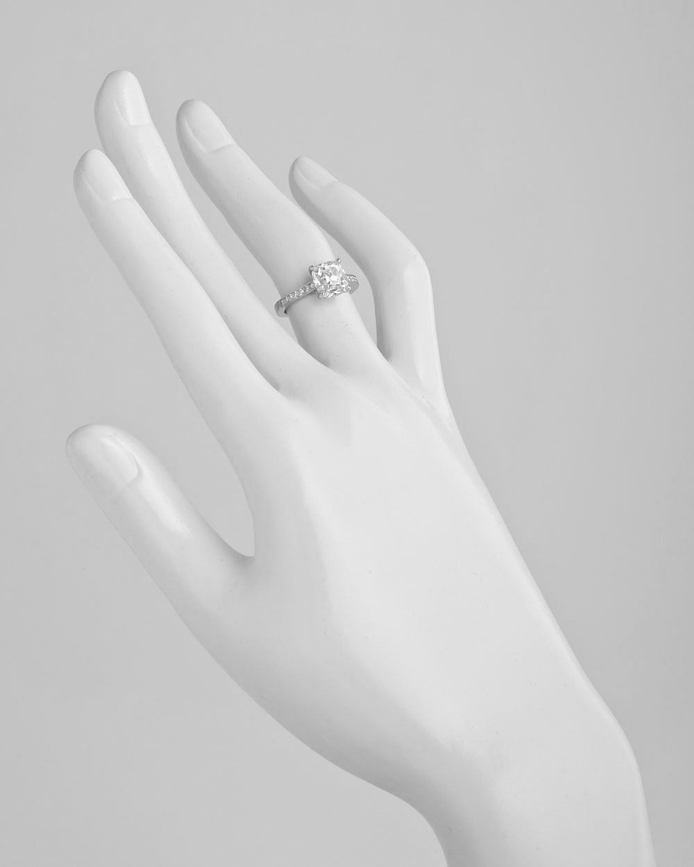 Diamond engagement ring, centering on a near-colorless cushion brilliant-cut diamond weighing 2.01 carats, with seven bead-set round diamonds at either shoulder and a bead-set diamond profile, mounted in platinum. Accompanied by the GIA certificate