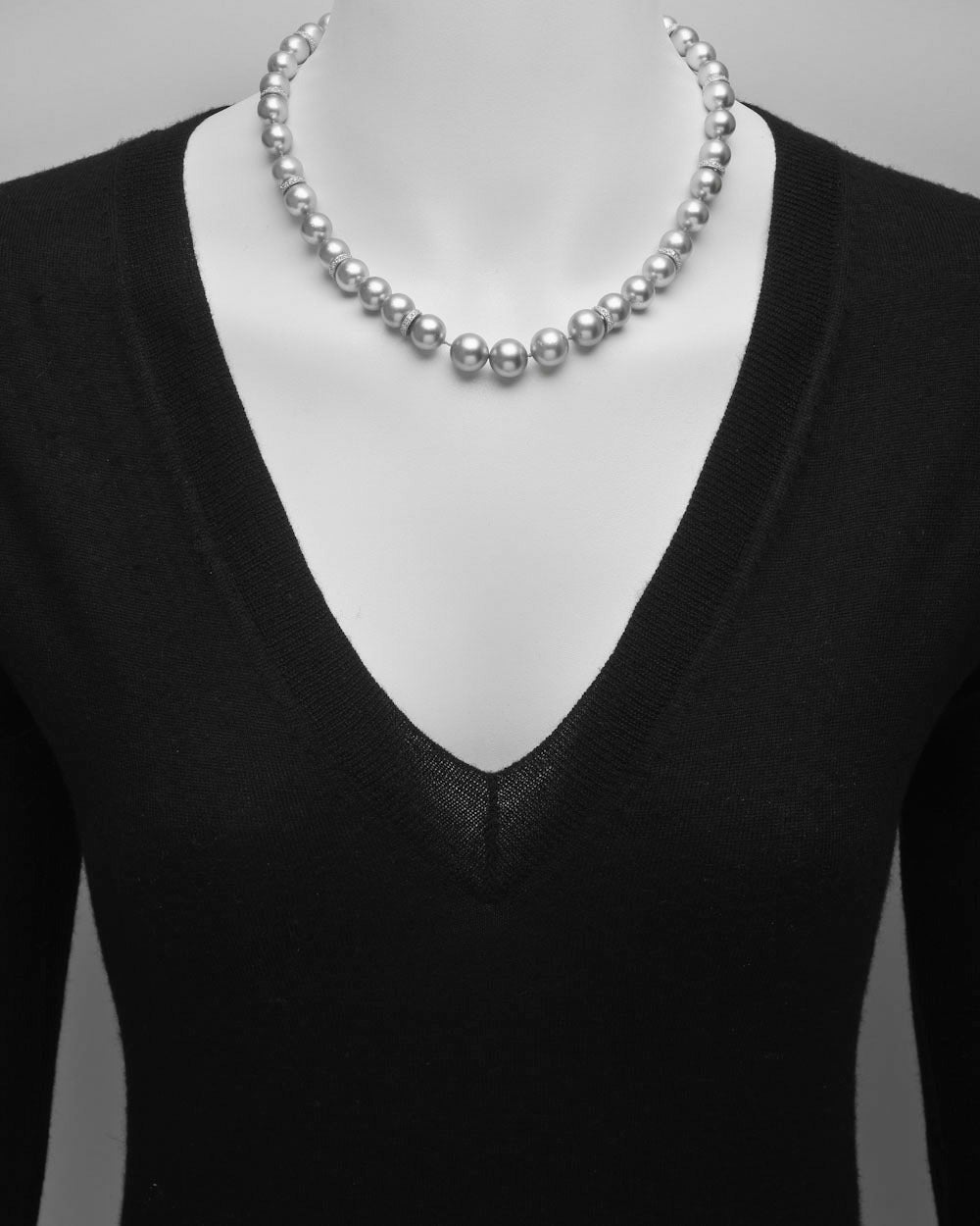 Gray pearl and diamond necklace, composed of 41 fine cultured pearls ranging from 8.5 to 10.5mm in diameter, accented by diamond-set rondels in 18k white gold, the pearls strung on a silk cord and secured by a pavé-set diamond flower clasp in 18k