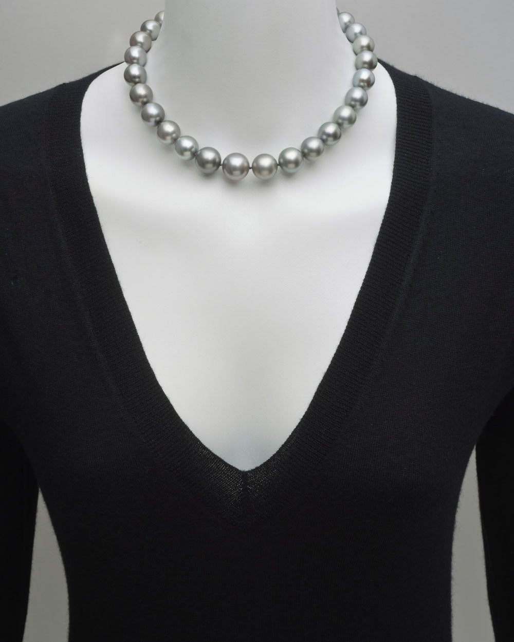South Sea pearl necklace, composed of 29 gray-toned South Sea pearls, ranging from 11.5 to 15.5mm in diameter, strung on a silk cord, with a 10.7mm pavé diamond ball clasp, mounted in platinum. 16