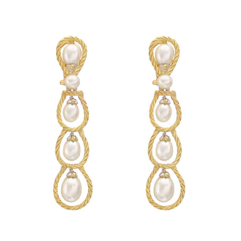 Multi-loop pendant earrings, with small drop pearls at each center and single button-shaped pearl above, with ten pearls total, mounted in hand-carved 18k yellow and white gold, with omega-style clip and post backs, signed Buccellati. 2.4