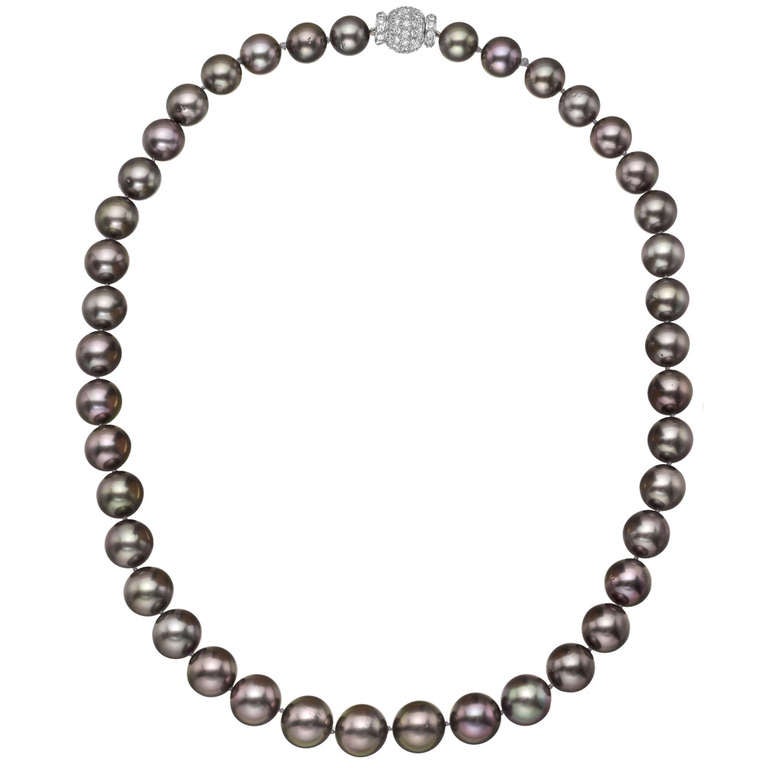 Single-strand Tahitian pearl necklace, composed of 41 graduated Tahitian cultured pearls, strung on a silk cord, with a pavé diamond and 18k white gold ball clasp. 20