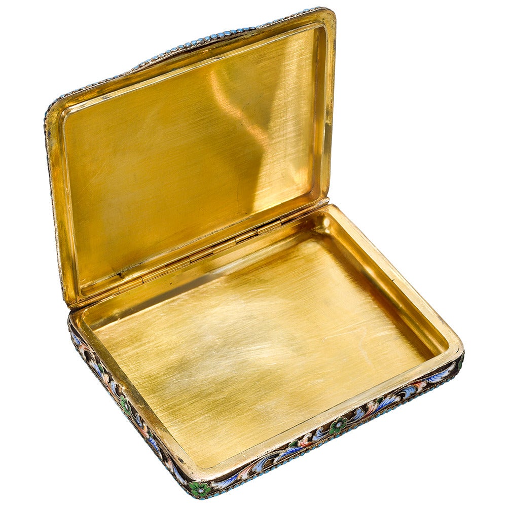 Late 19th century Russian silver gilt and cloisonné enamel cigarette case, with scrolling floral motifs throughout the exterior of the case in pink, green, blue, silver & white enamel, the case engraved with the letter 'L', by Ivan Zakharov. Ivan
