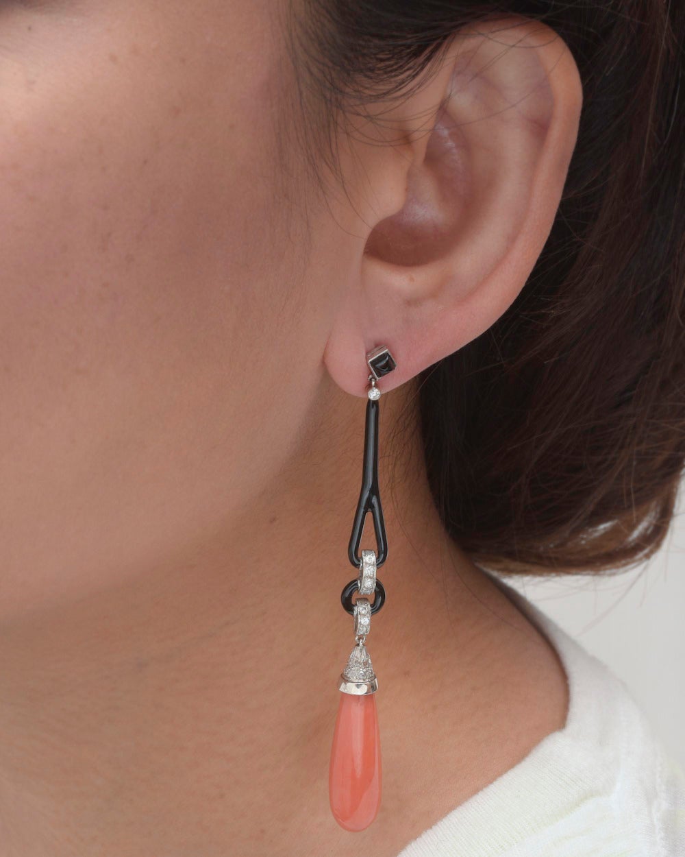 Coral, diamond, black enamel and onyx pendant earrings, designed as vintage coral drops with rose-cut diamond-set caps on contemporary long black enamel and full-cut diamond-set links to a carved black onyx square-shaped surmount, mounted in