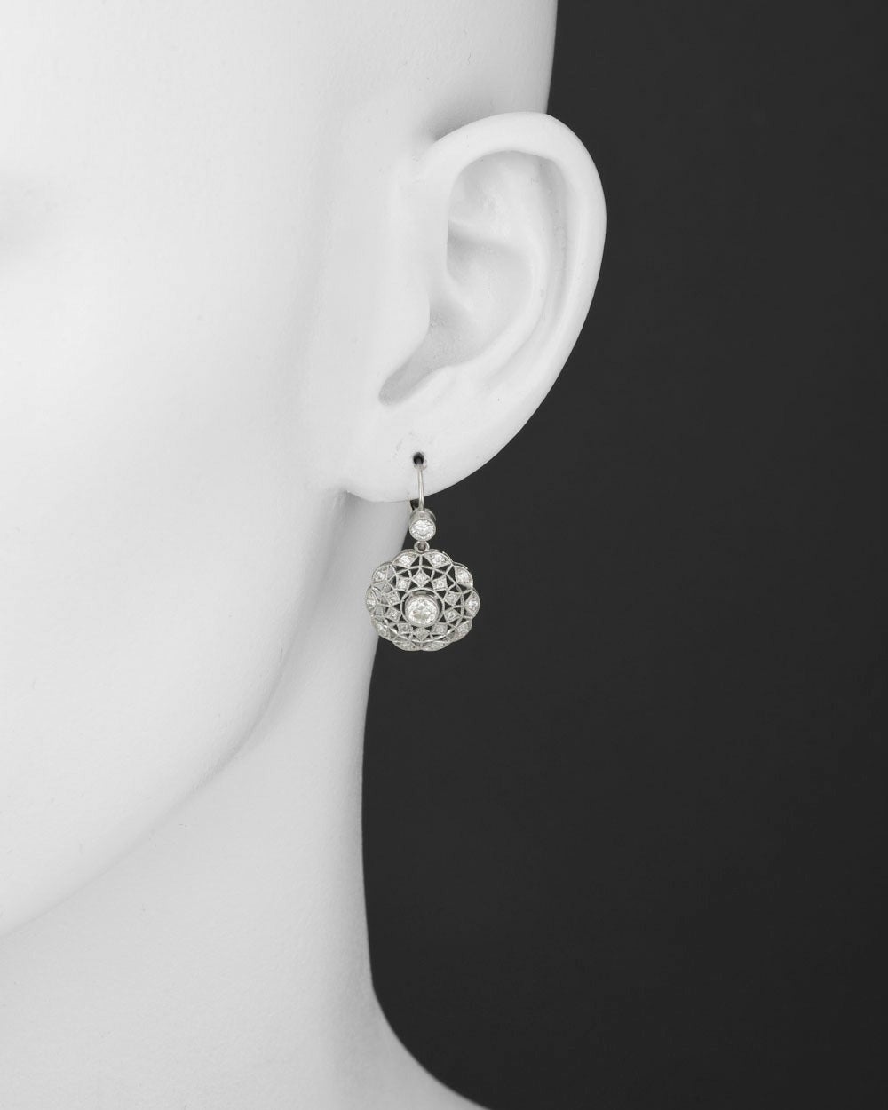 Diamond filigree drop earrings, with round diamonds weighing approximately 1.60 total carats, mounted in platinum, on a French wire with hinged enclosure. 1.10