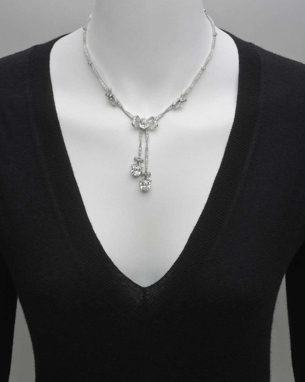 Belle Époque diamond bowknot motif necklace, the delicate twist ribbon mount set with 128 rose and old mine-cut diamonds weighing approximately 4.10 total carats, 6 collet-set diamonds weighing approximately 0.50 total carats, and 2 small bowknot