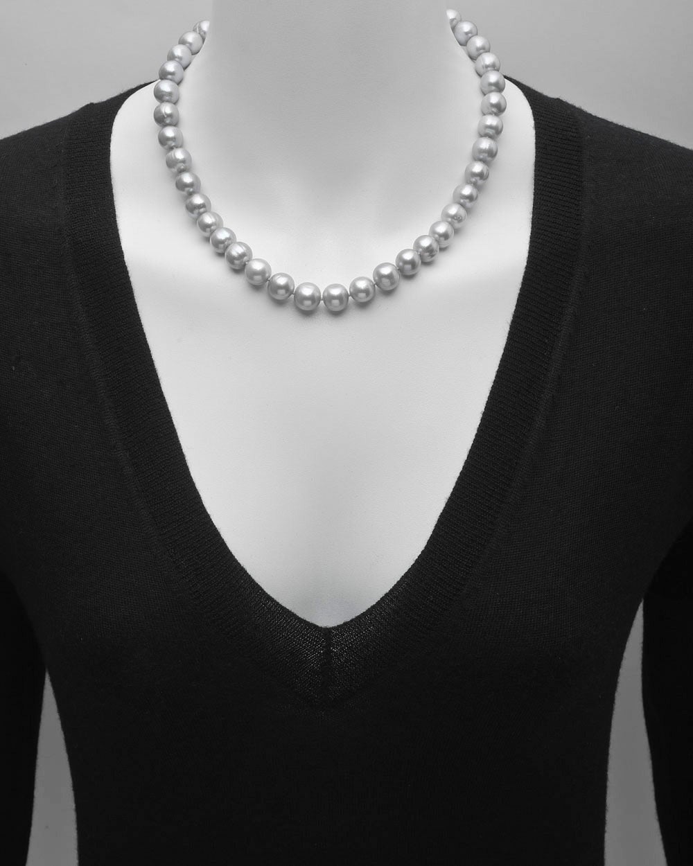 Round and semi-baroque cultured Tahitian pearl necklace, composed of 41 light gray pearls ranging from 9.9 to 11.2mm in diameter, strung on a silk cord, with a pierced, navette-shaped plunger-style clasp in sterling silver. 18